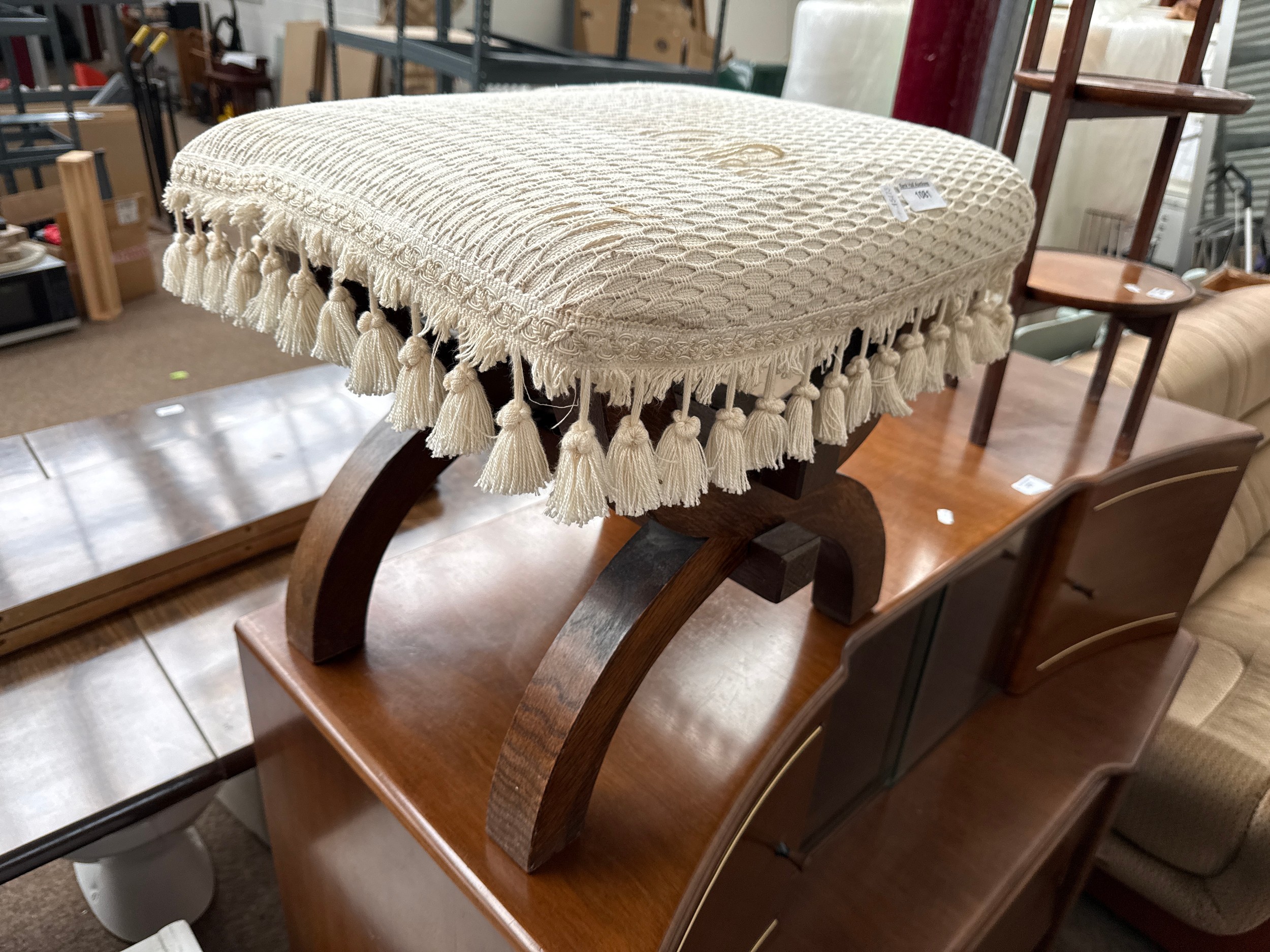 A small vintage upholstered oak saddle stool
