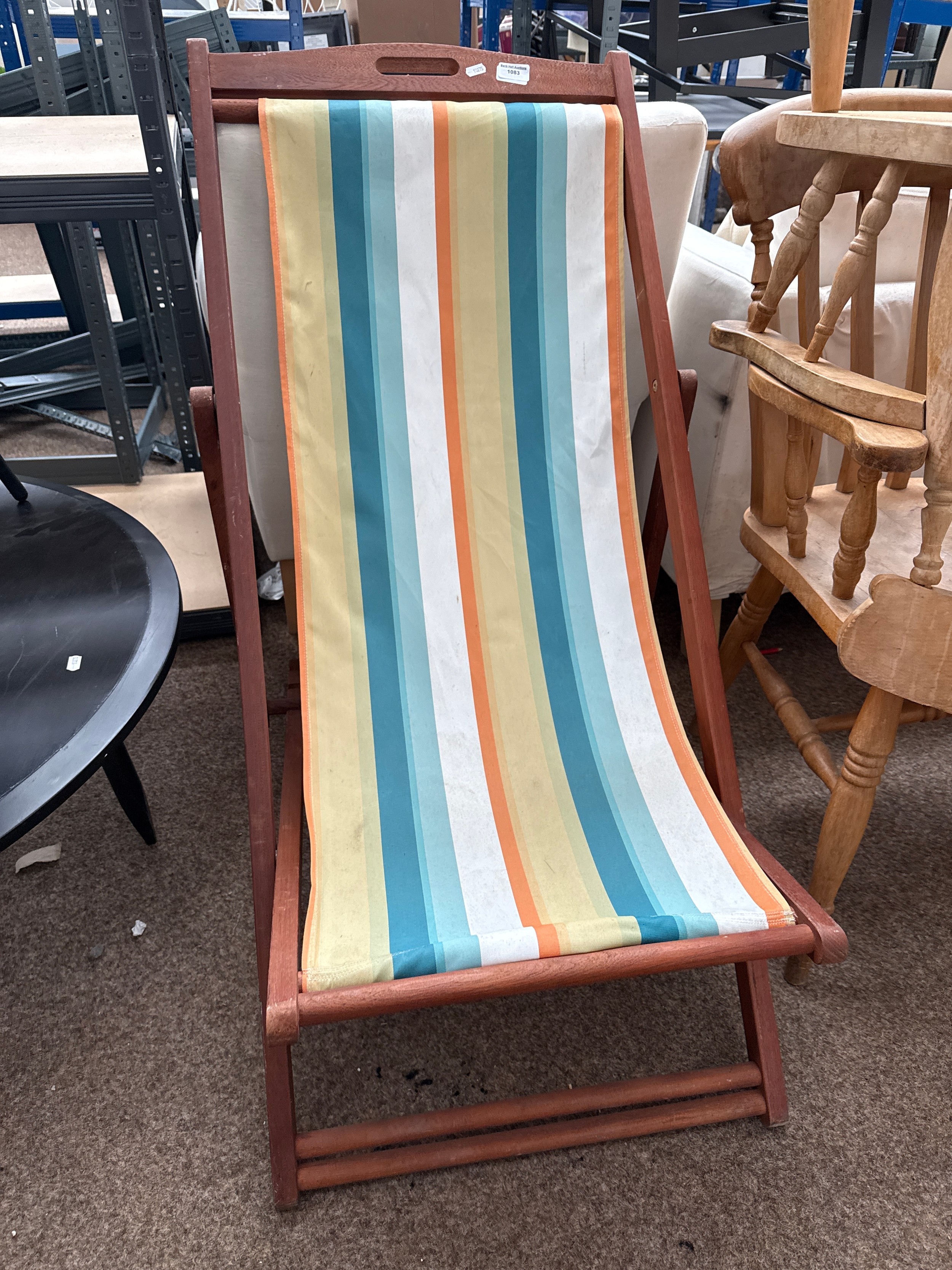 A vintage style wood framed folding deck chair