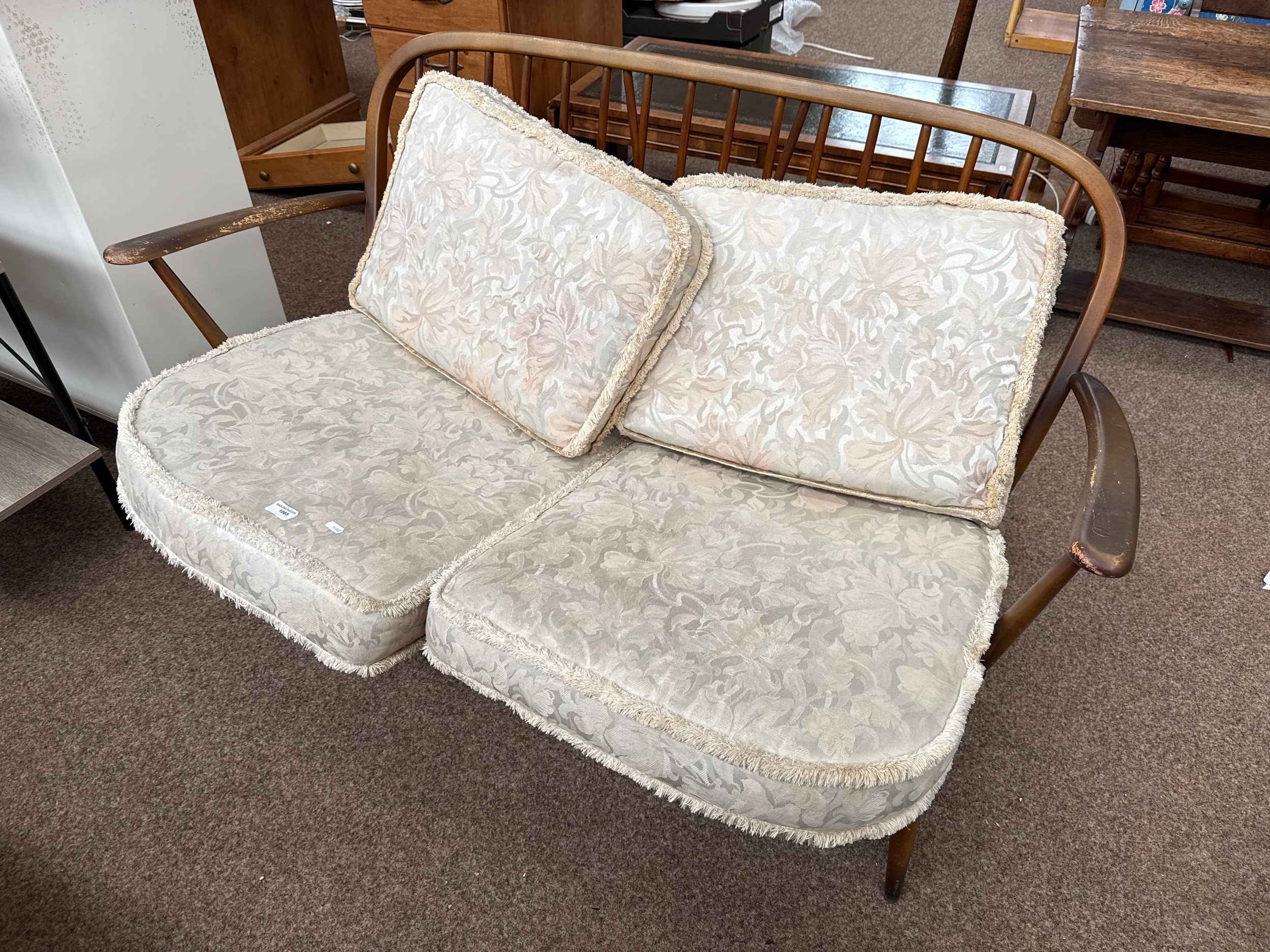 A vintage ERCOL spindle back 2 seater sofa with cushions