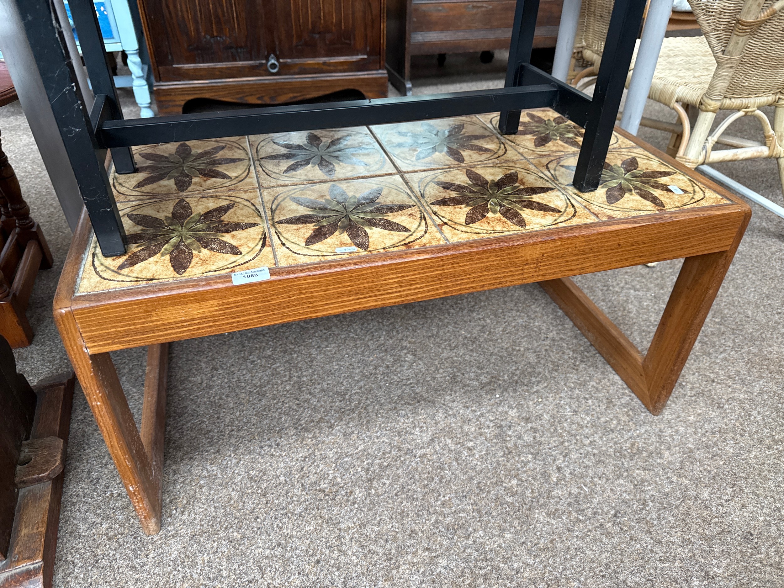 A small retro teak tile topped coffee table