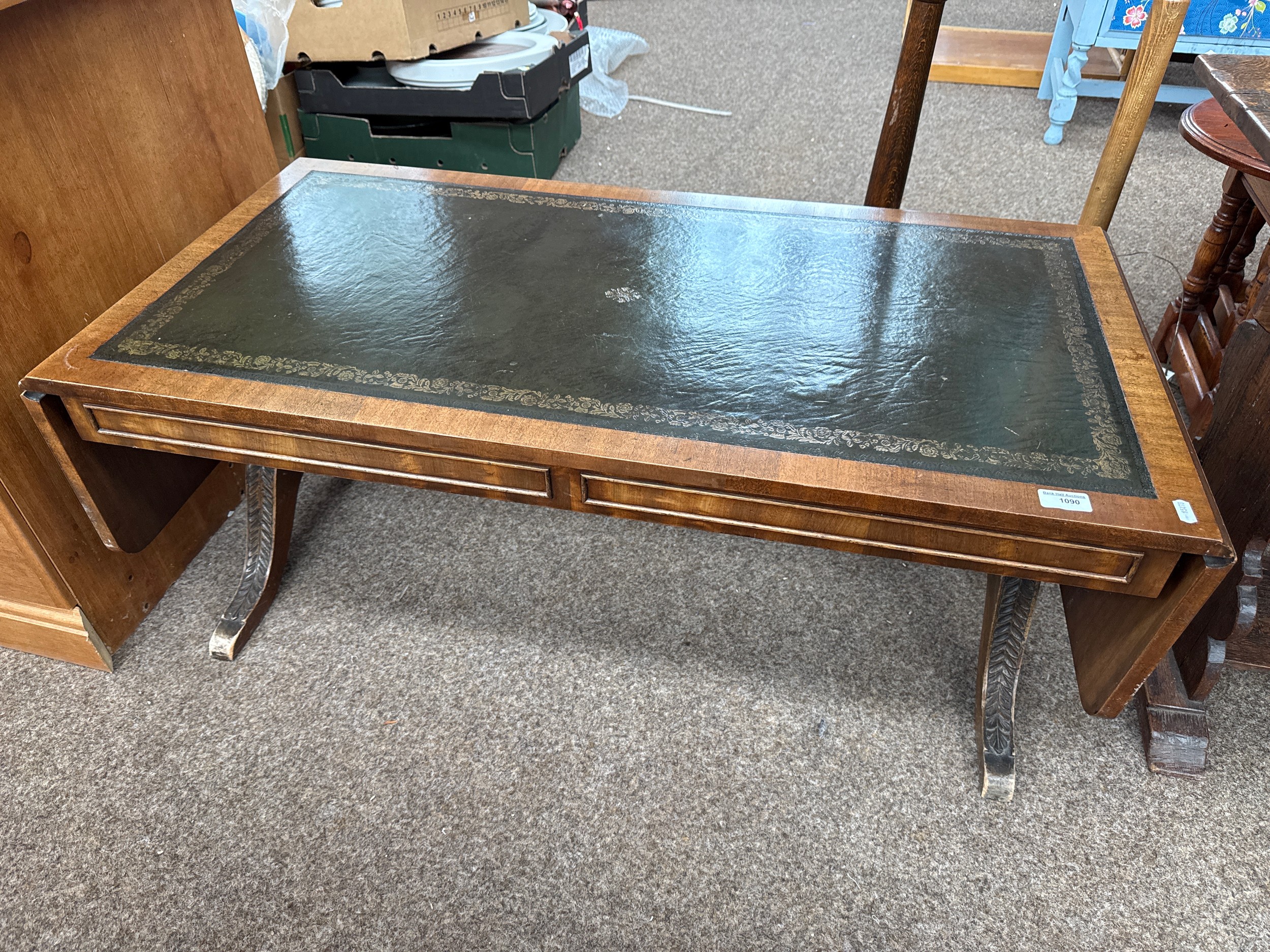 A vintage leather topped extending drop leaf sofa table