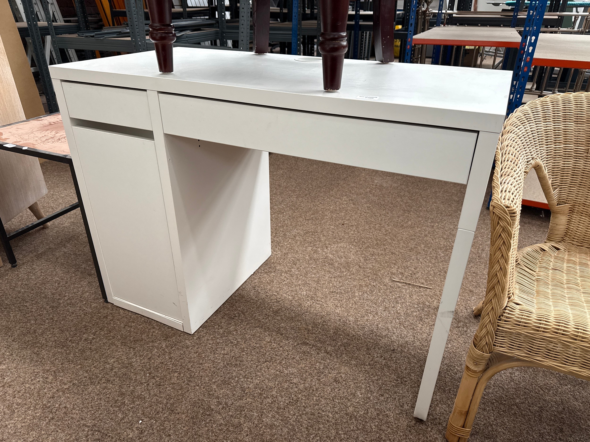 A small white 2 drawer desk with cupboard