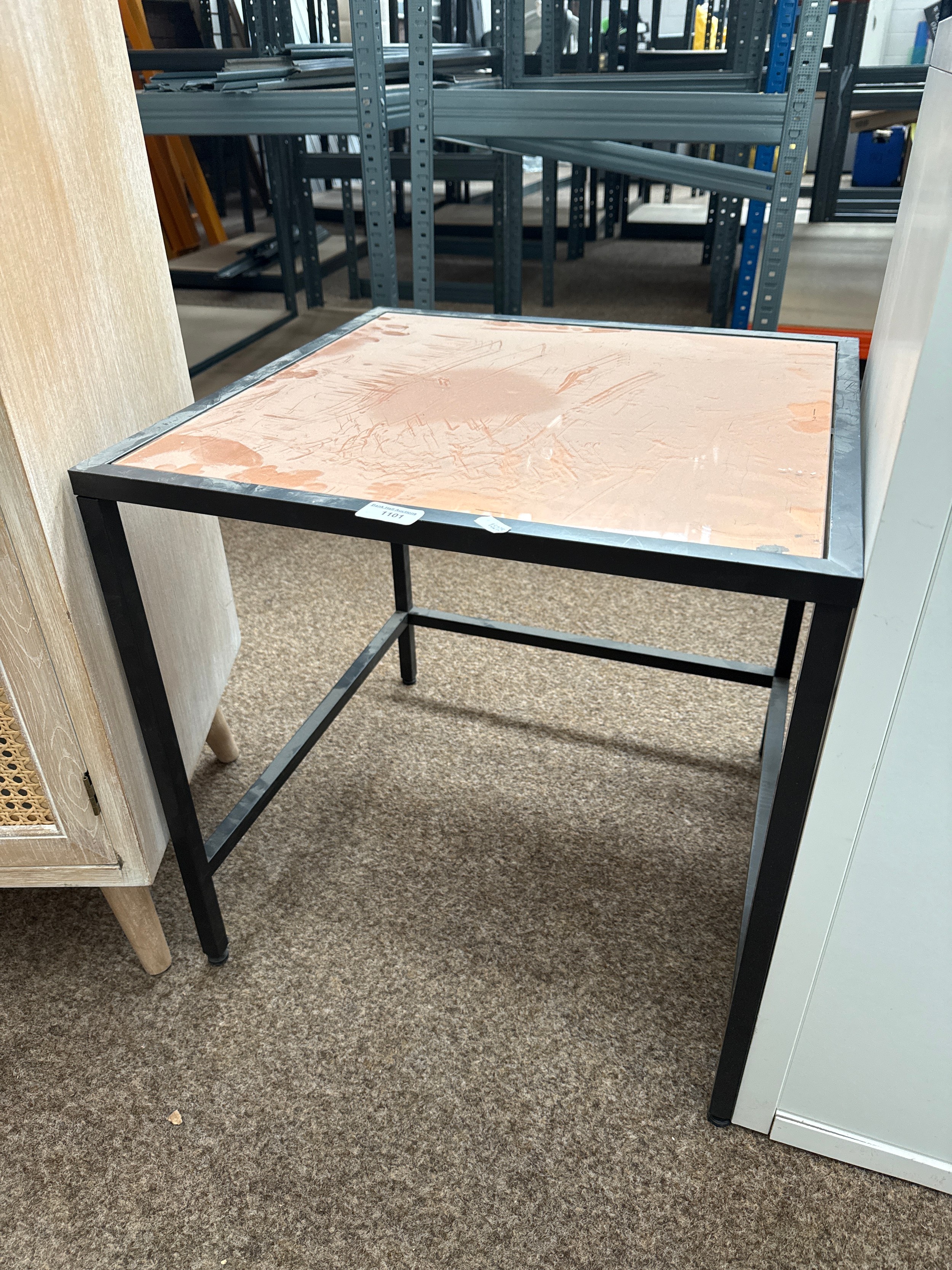 A small square glass topped occasional table