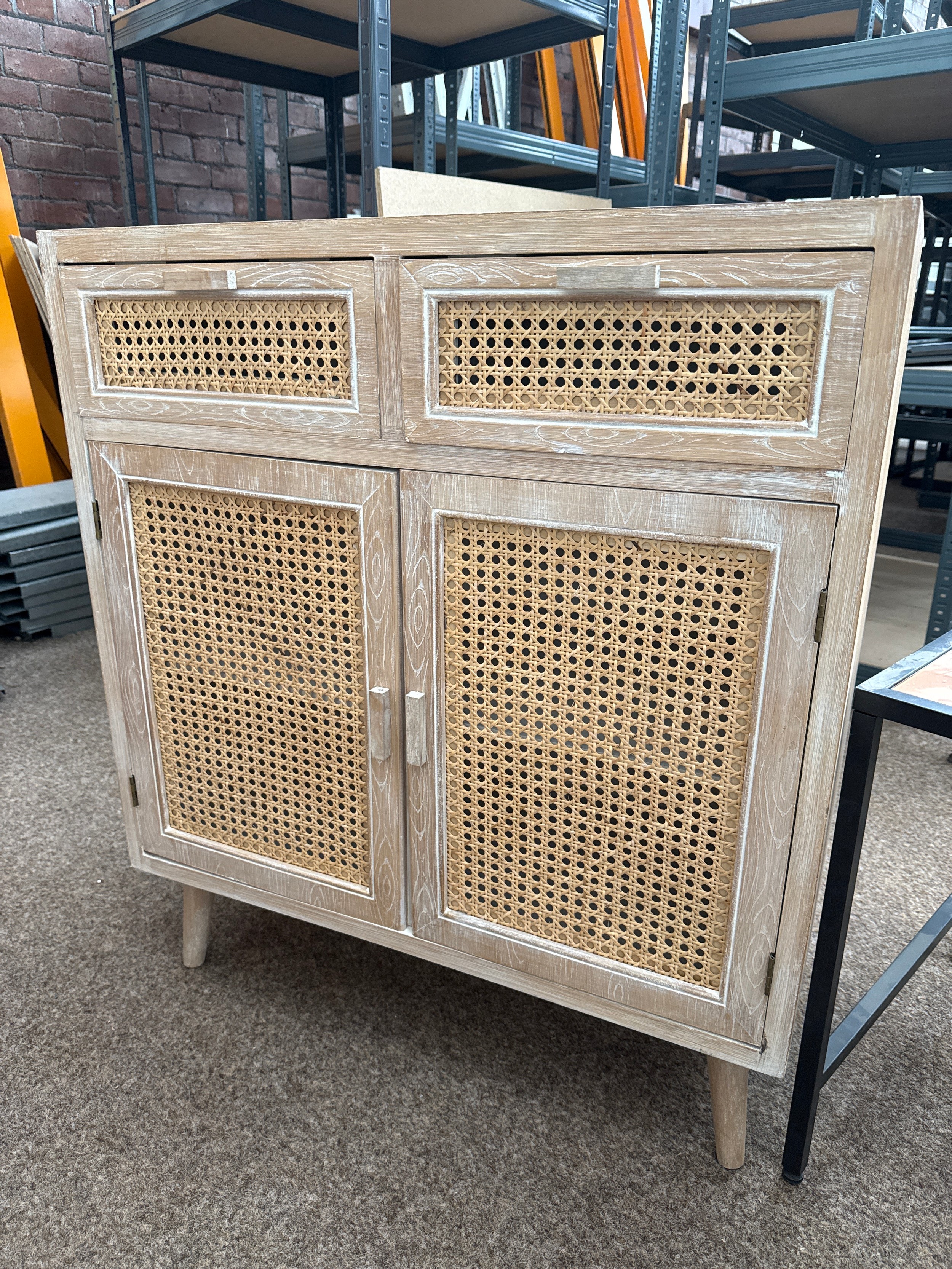 A small 2 drawer base unit cabinet with rattan panels