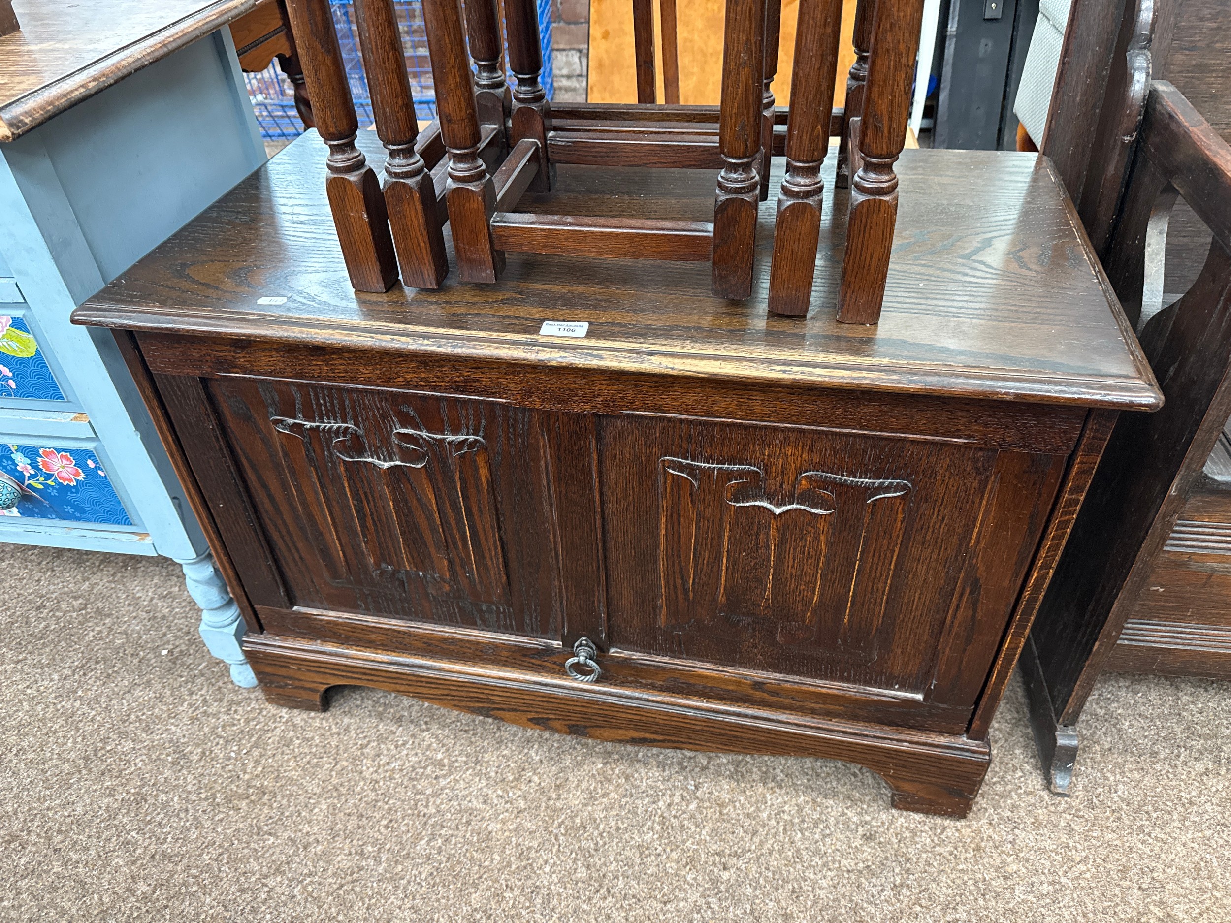 A vintage oak base storage/TV stand unit with lift up linenfold front panel
