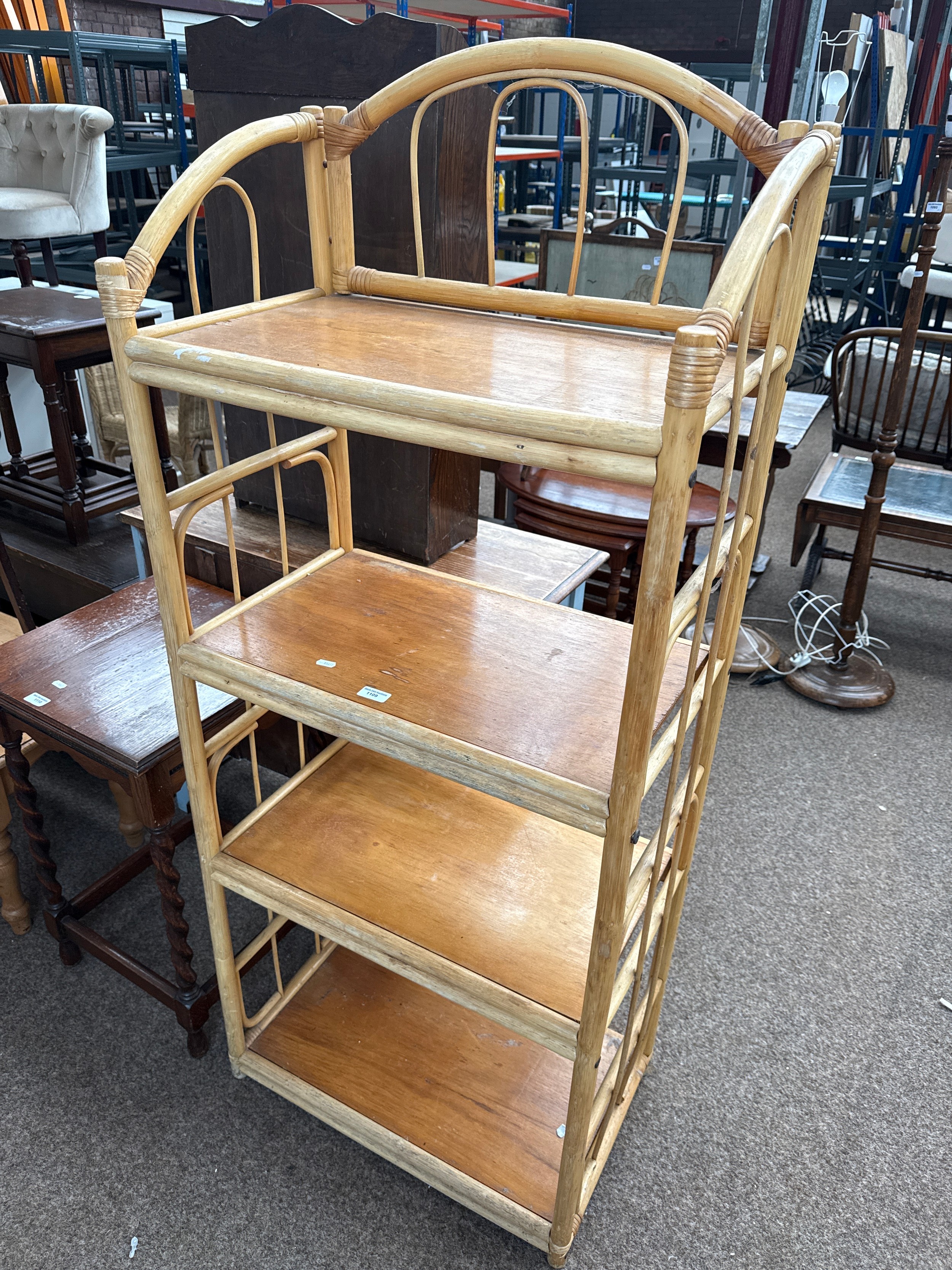 A 4 tier cane framed shelf stand