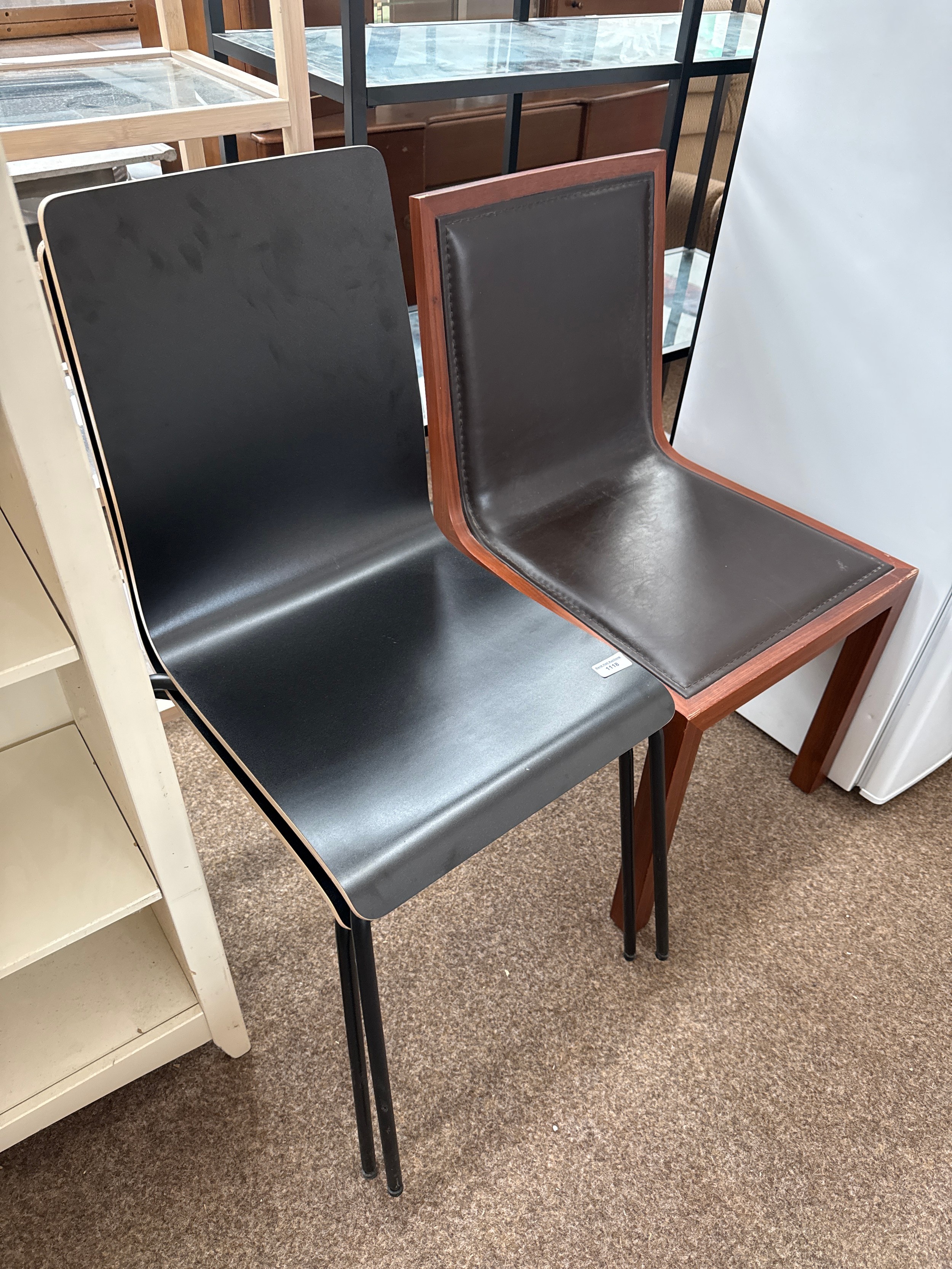 A pair of stacking chairs and a wood framed chair with padded seat