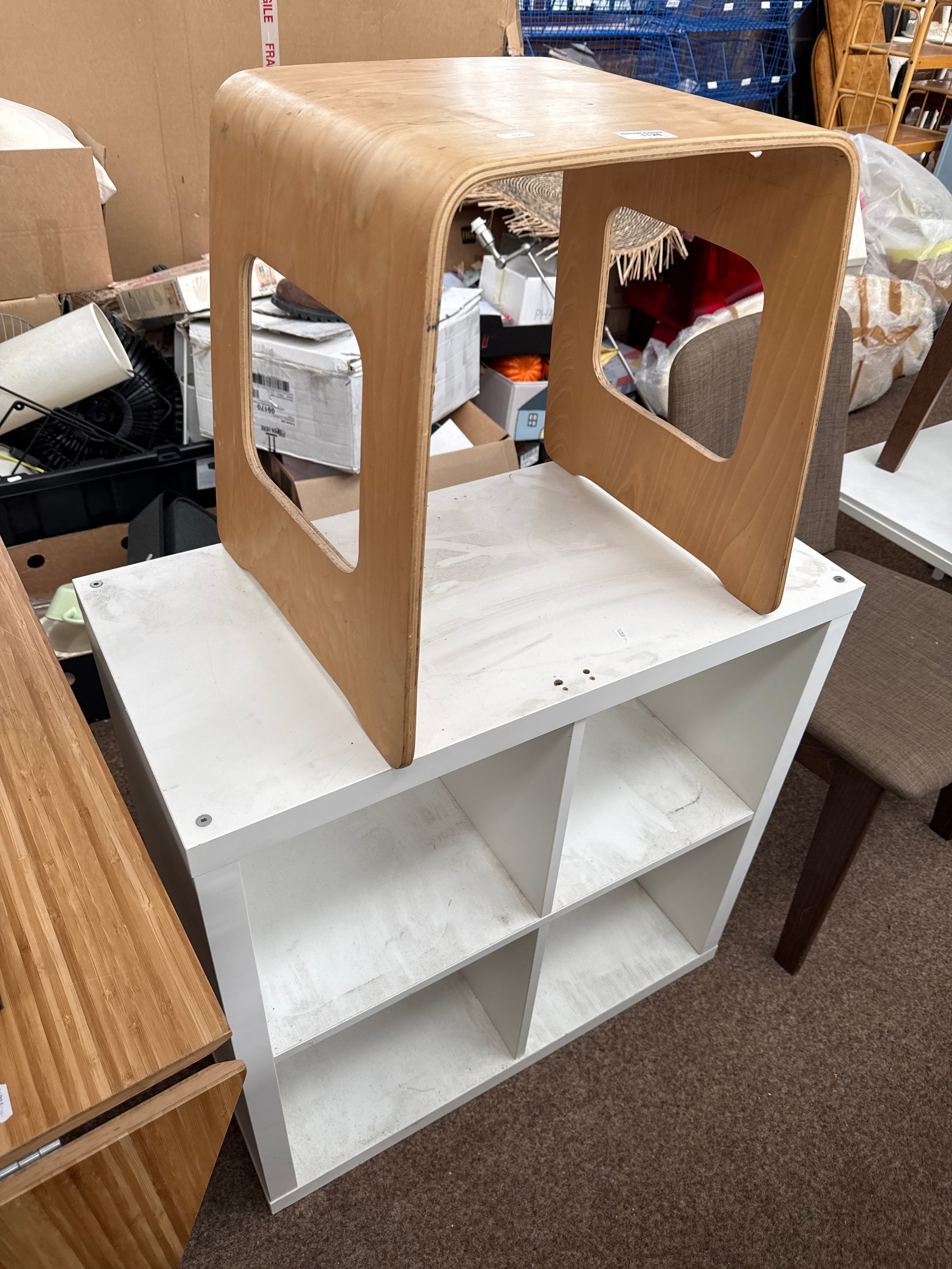A white cubed display unit and a ply occasional table