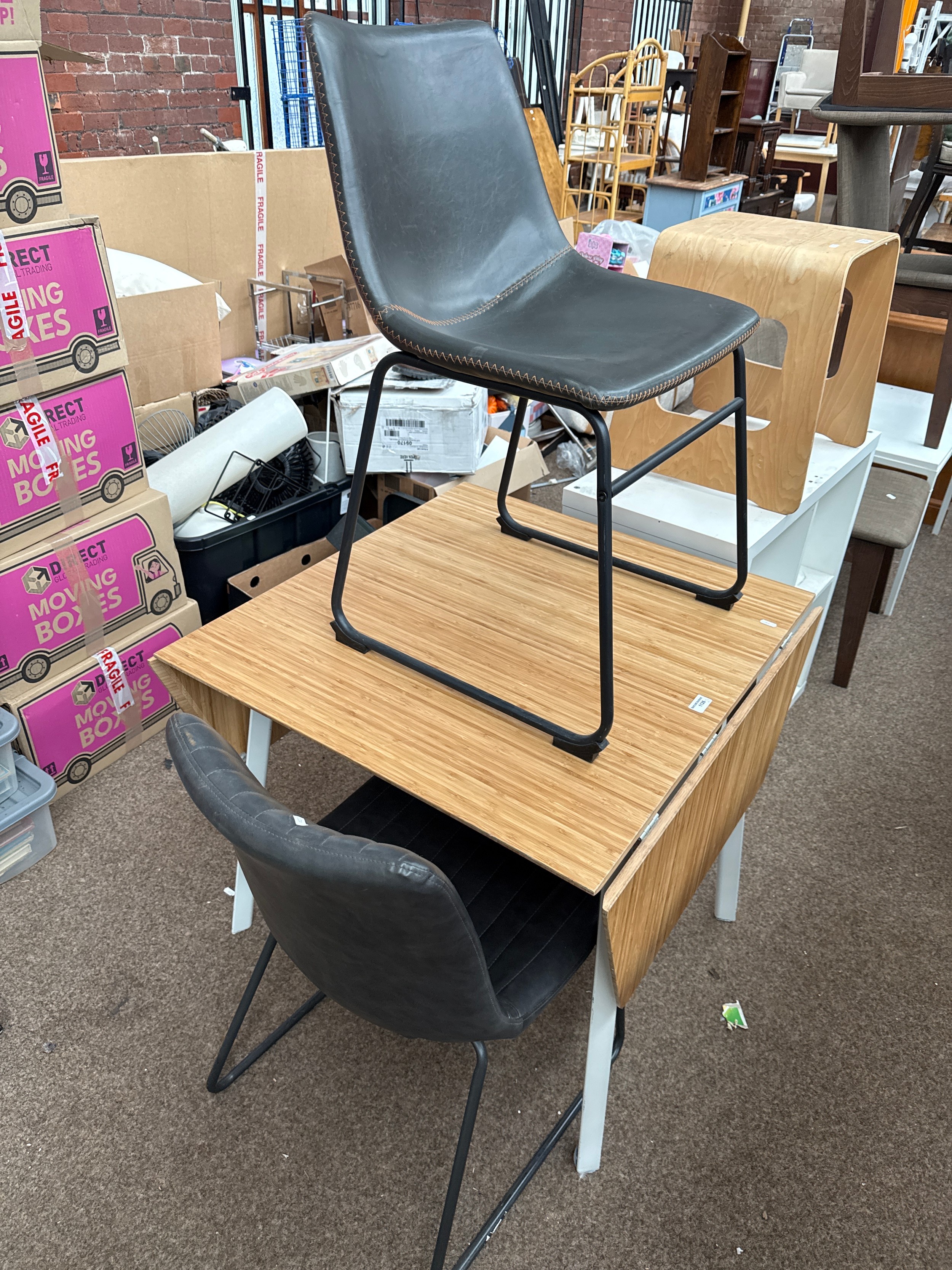 A modern drop leaf dining table and 2 x padded vinyl seated chairs