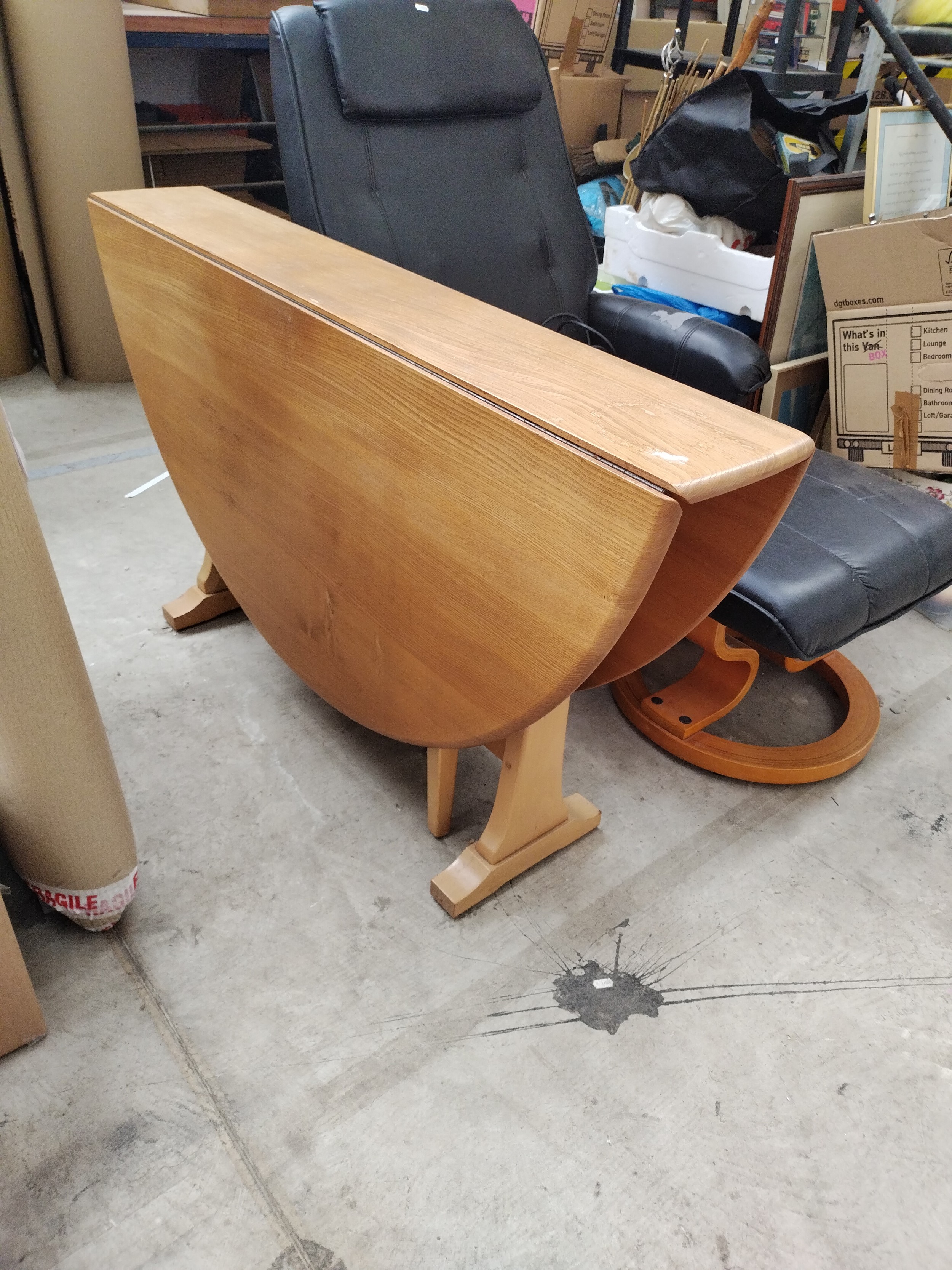 A large blond ERCOL gate leg dining table