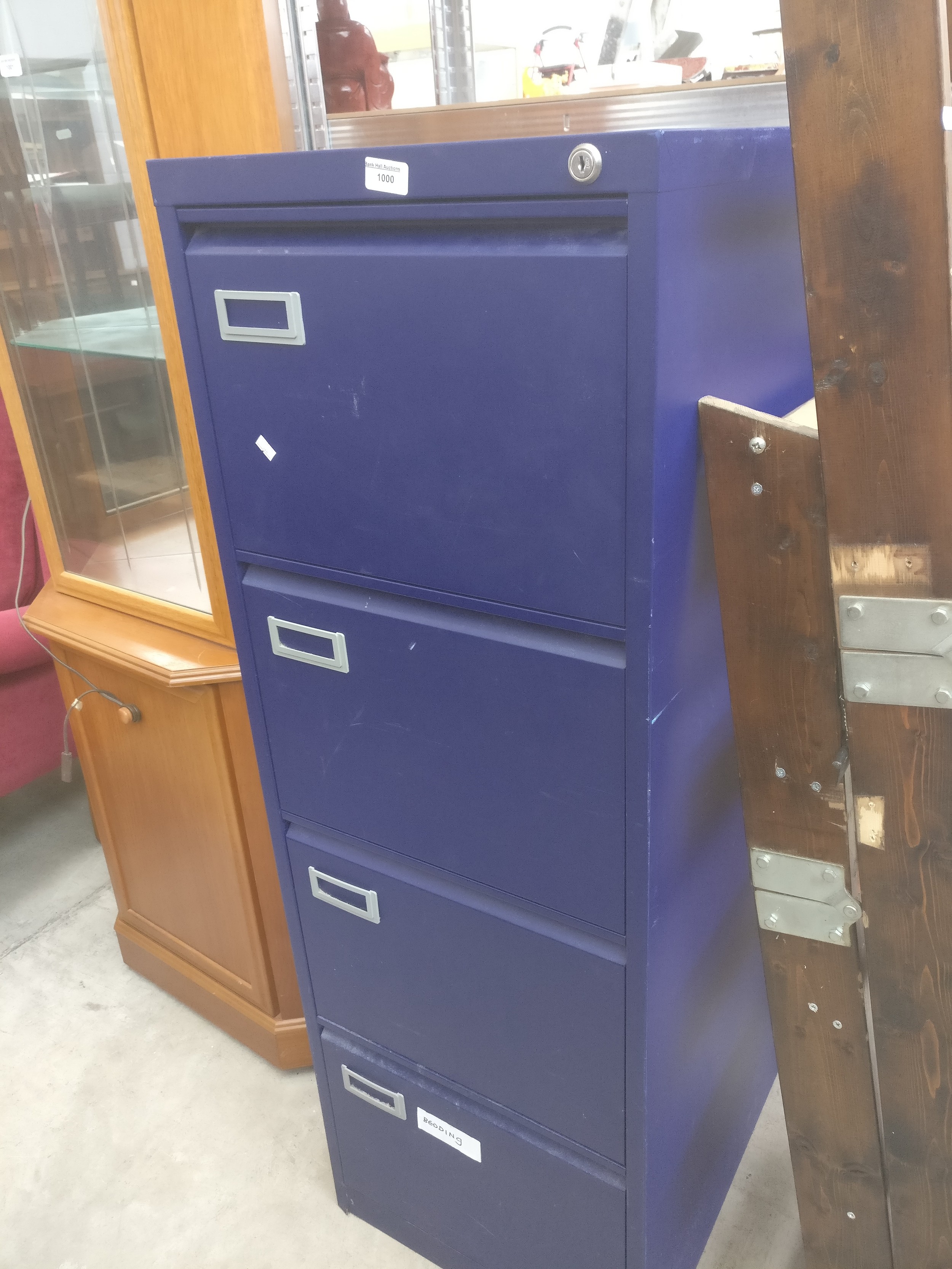 A vintage 4 drawer metal filing cabinet