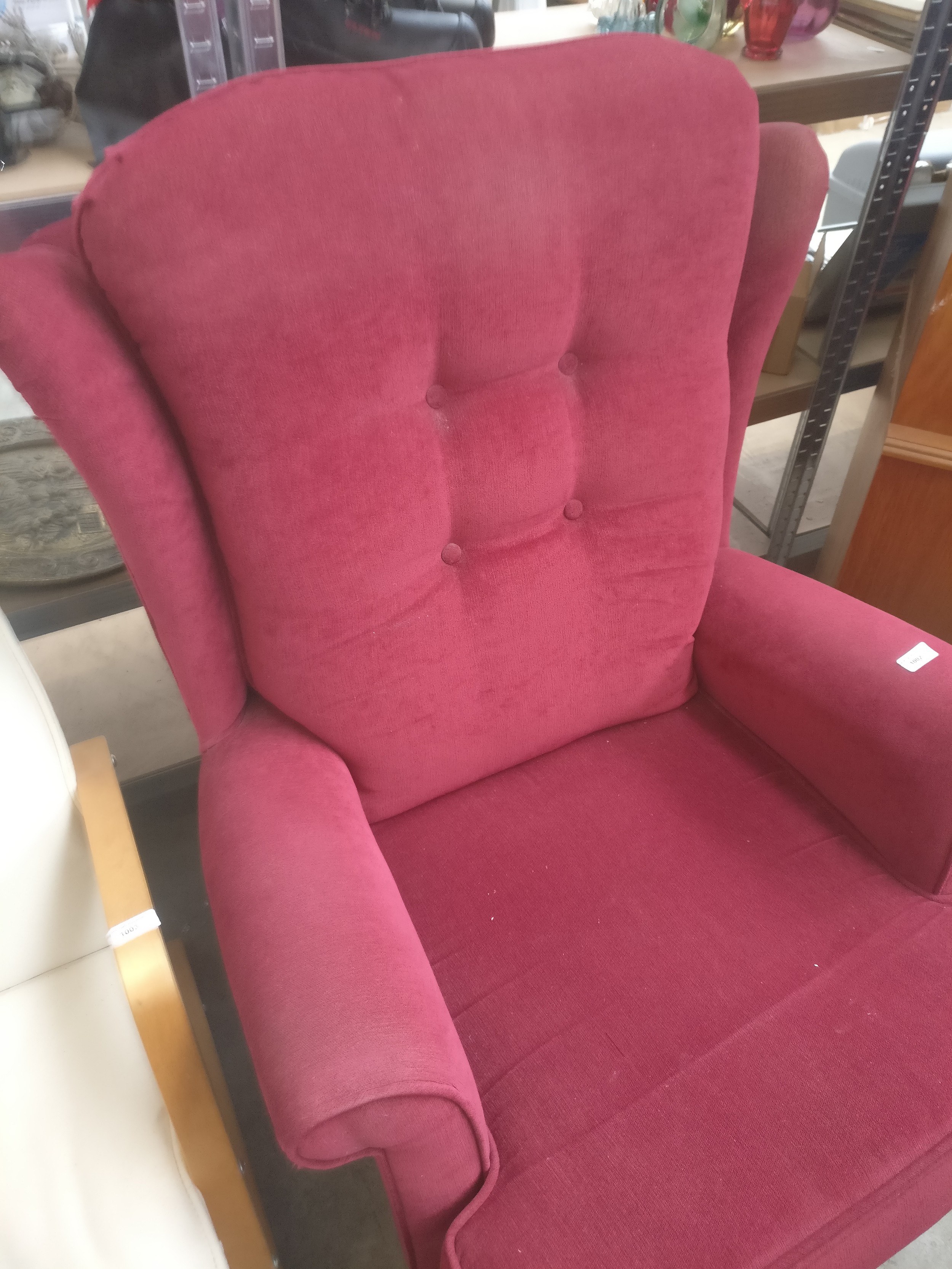 A vintage button backed wing back armchair