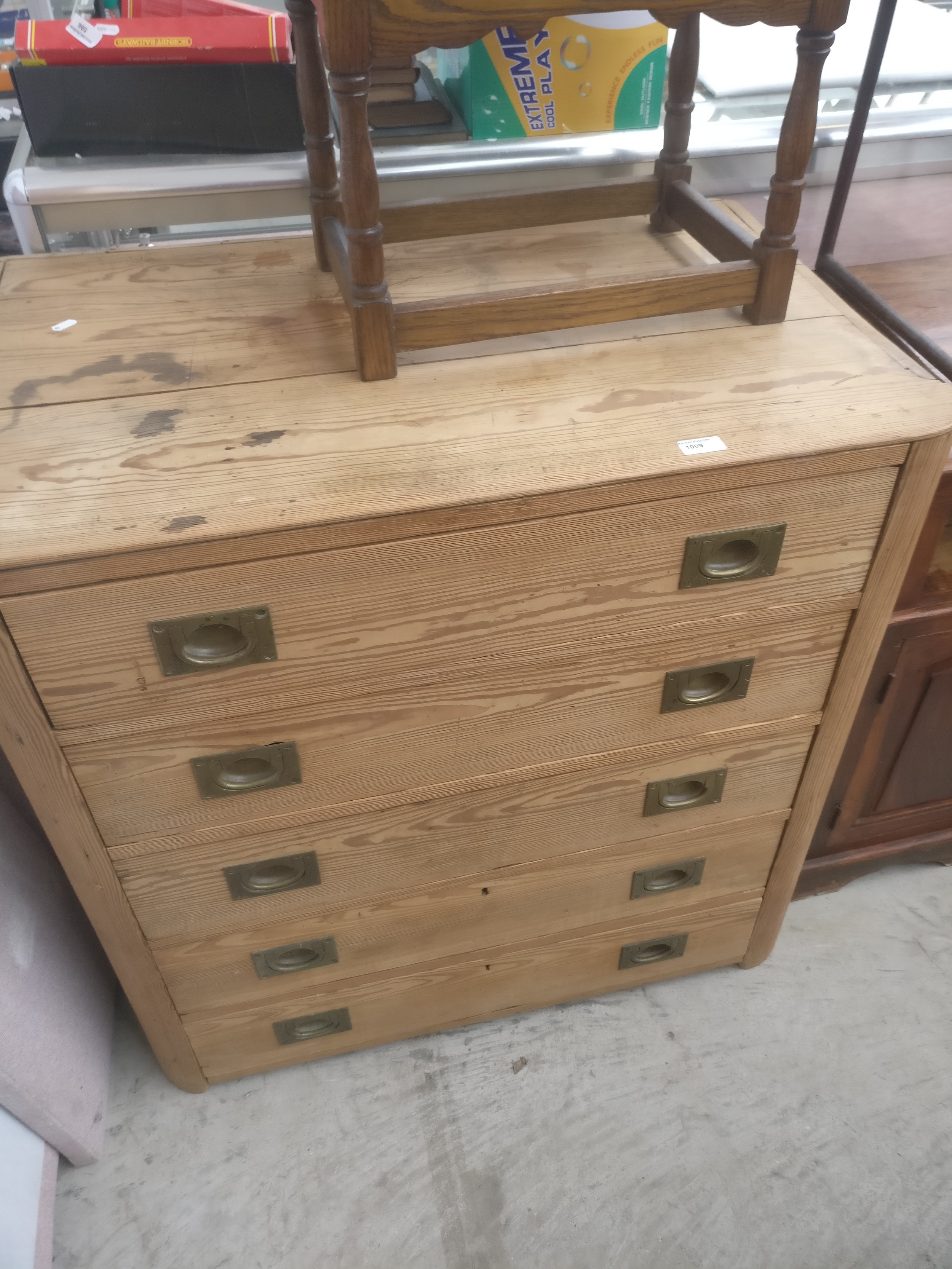 A vintage pine 5 drawer chest with cupped brass handles