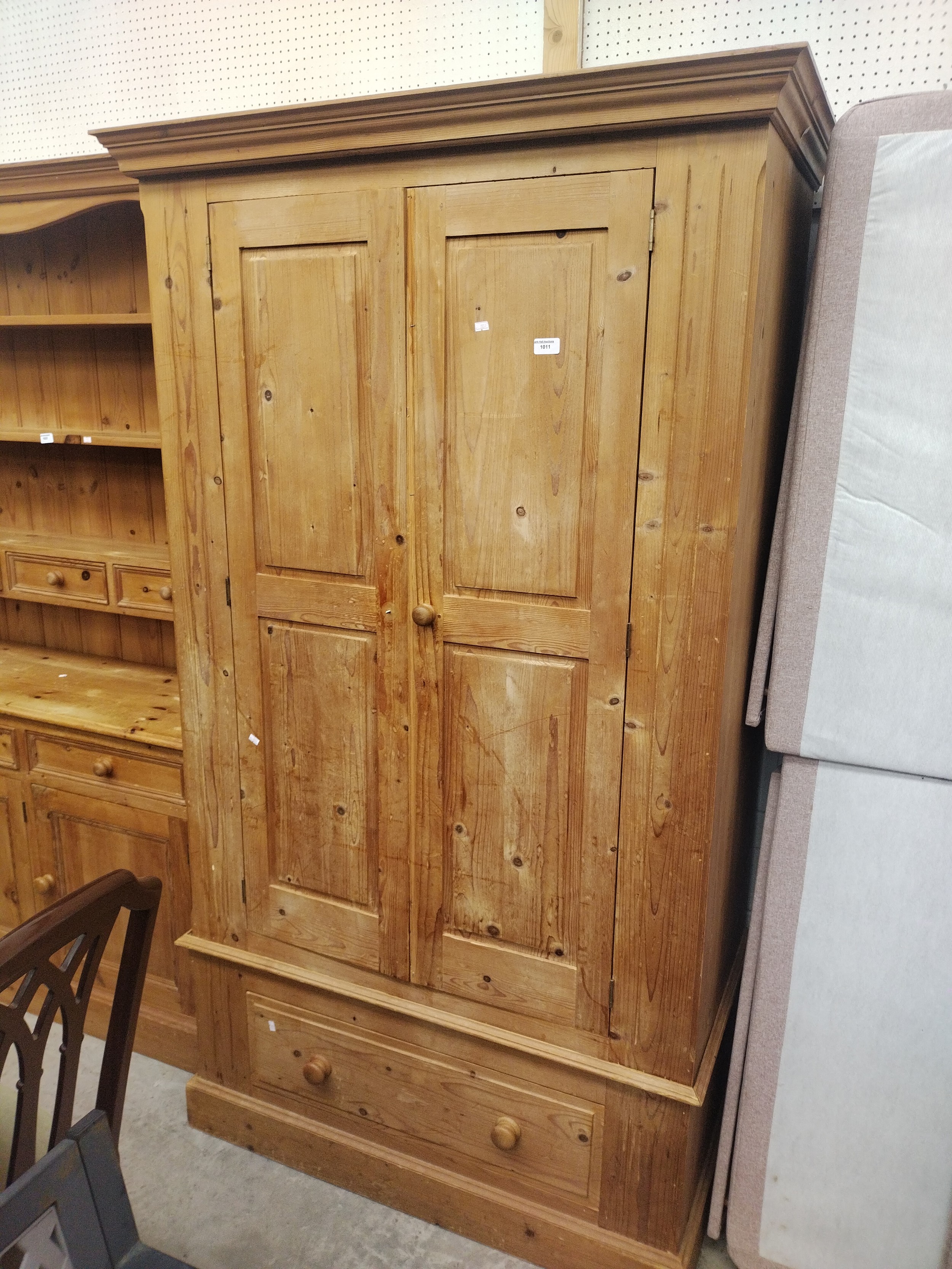 A large vintage pine 2 door wardrobe with lower drawer - one missing handle knob
