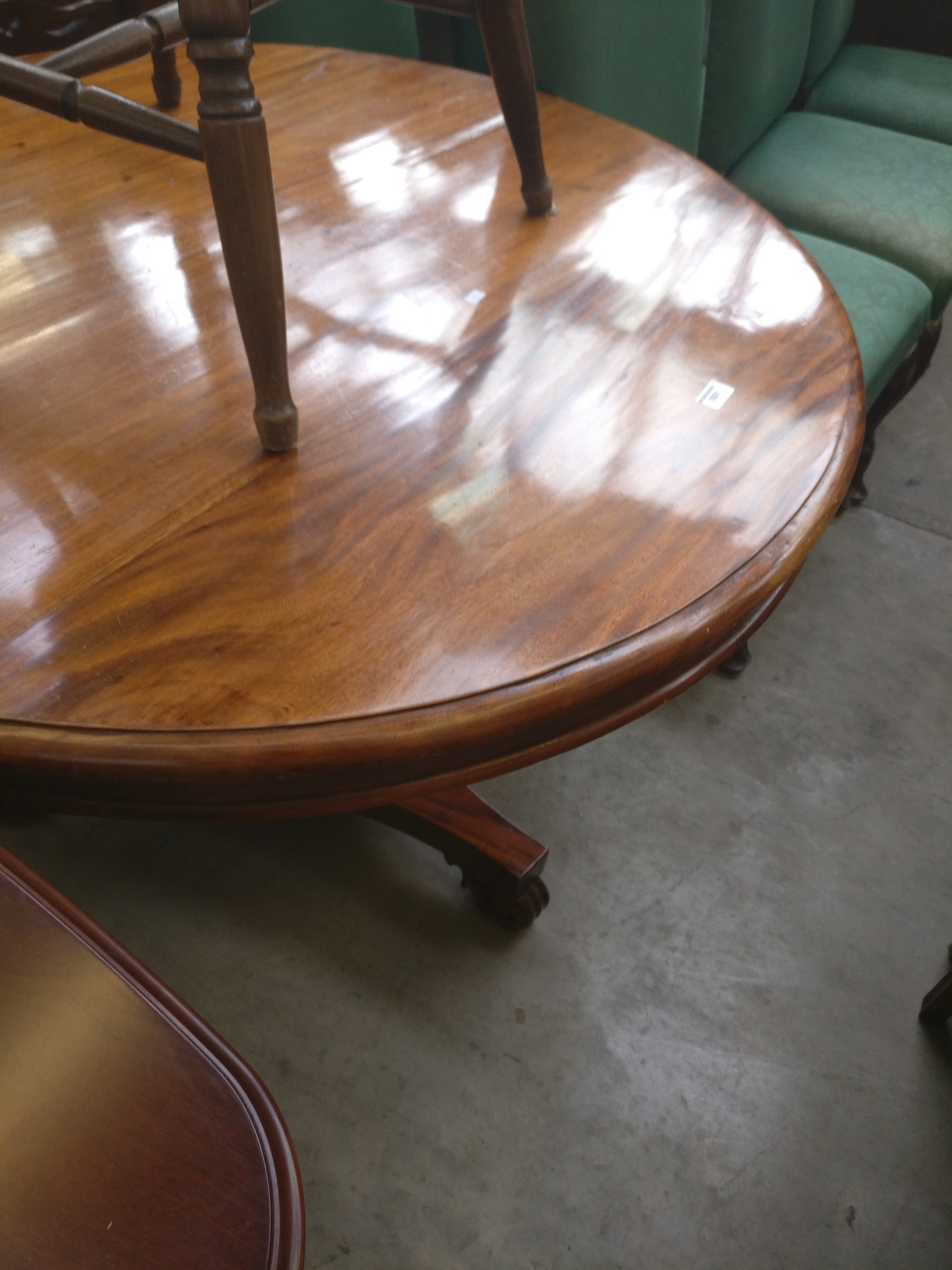 A vintage circular mahogany pedestal dining table with bulbous tripod base