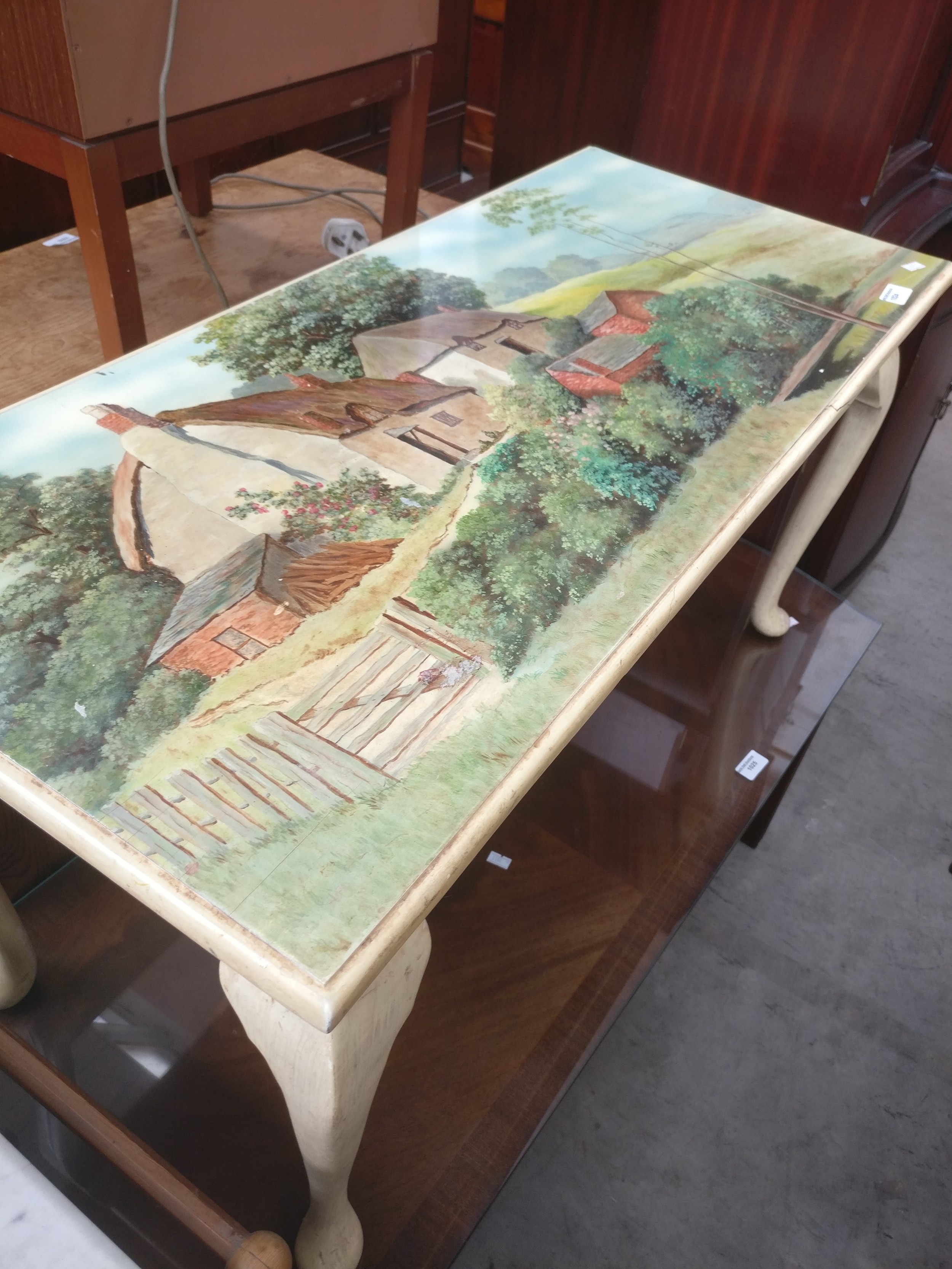 A painted vintage coffee table with decorative Cottage scene top