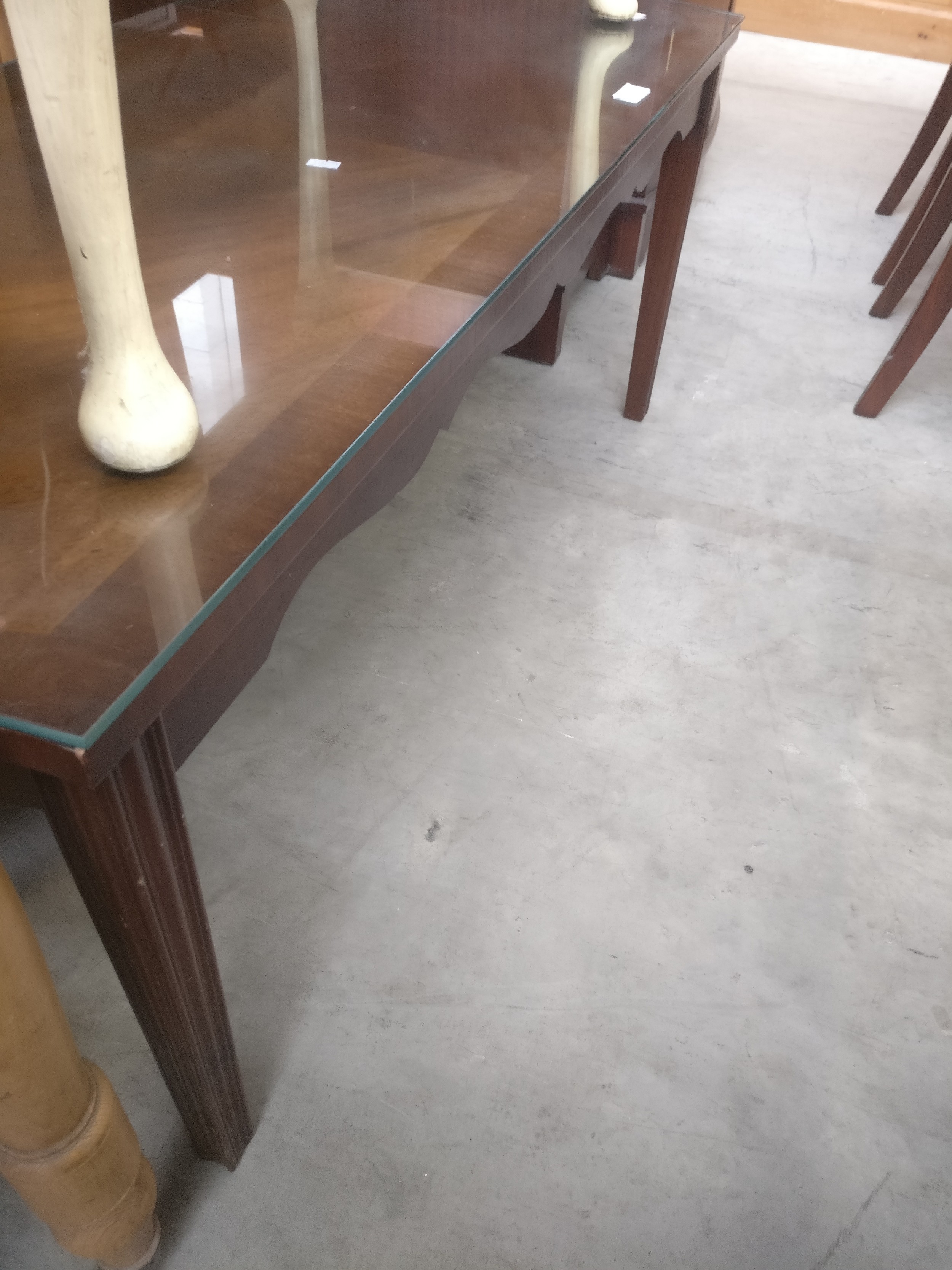A vintage flame mahogany coffee table with glass top protector