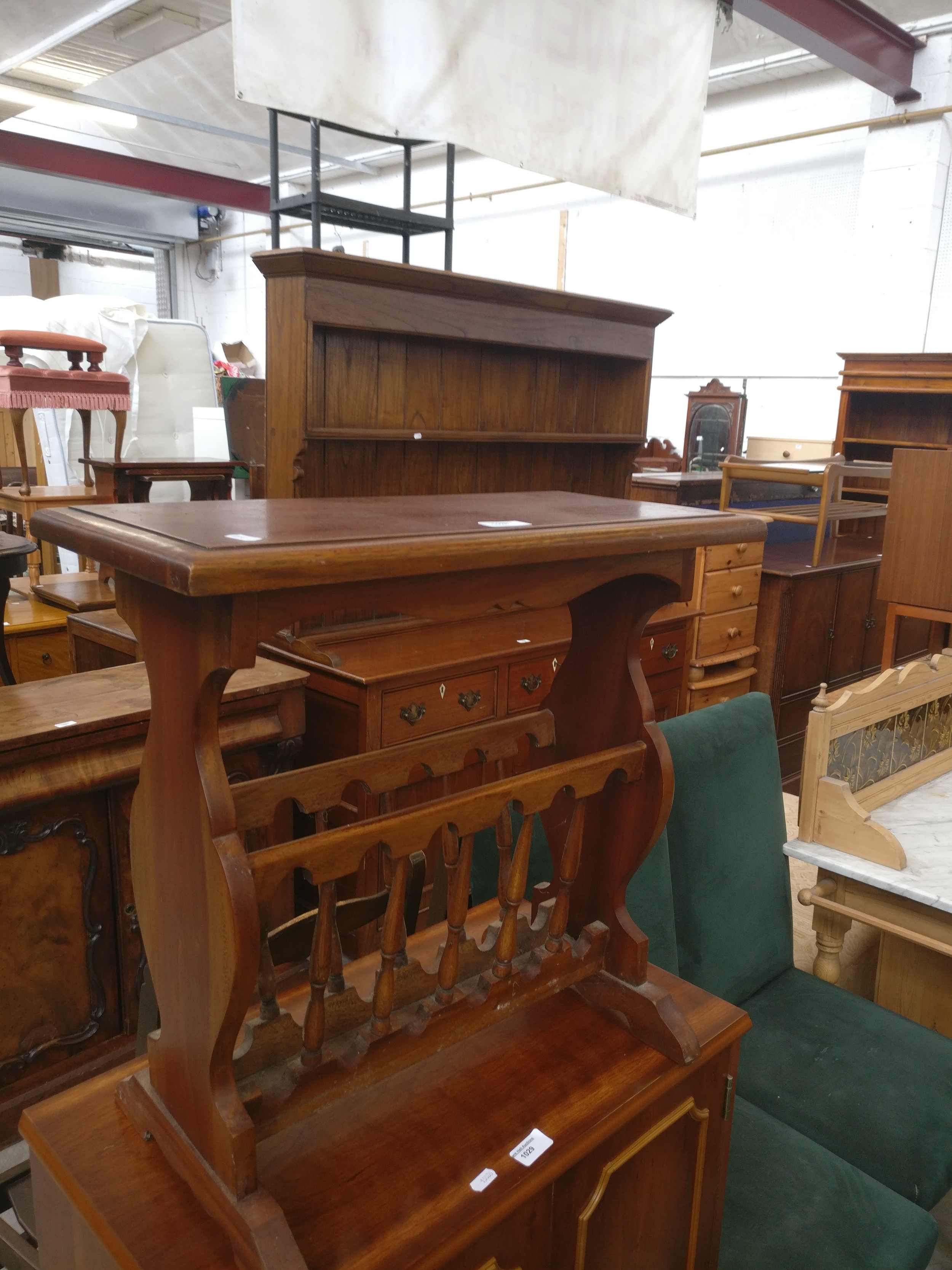 A small vintage hardwood magazine rack table