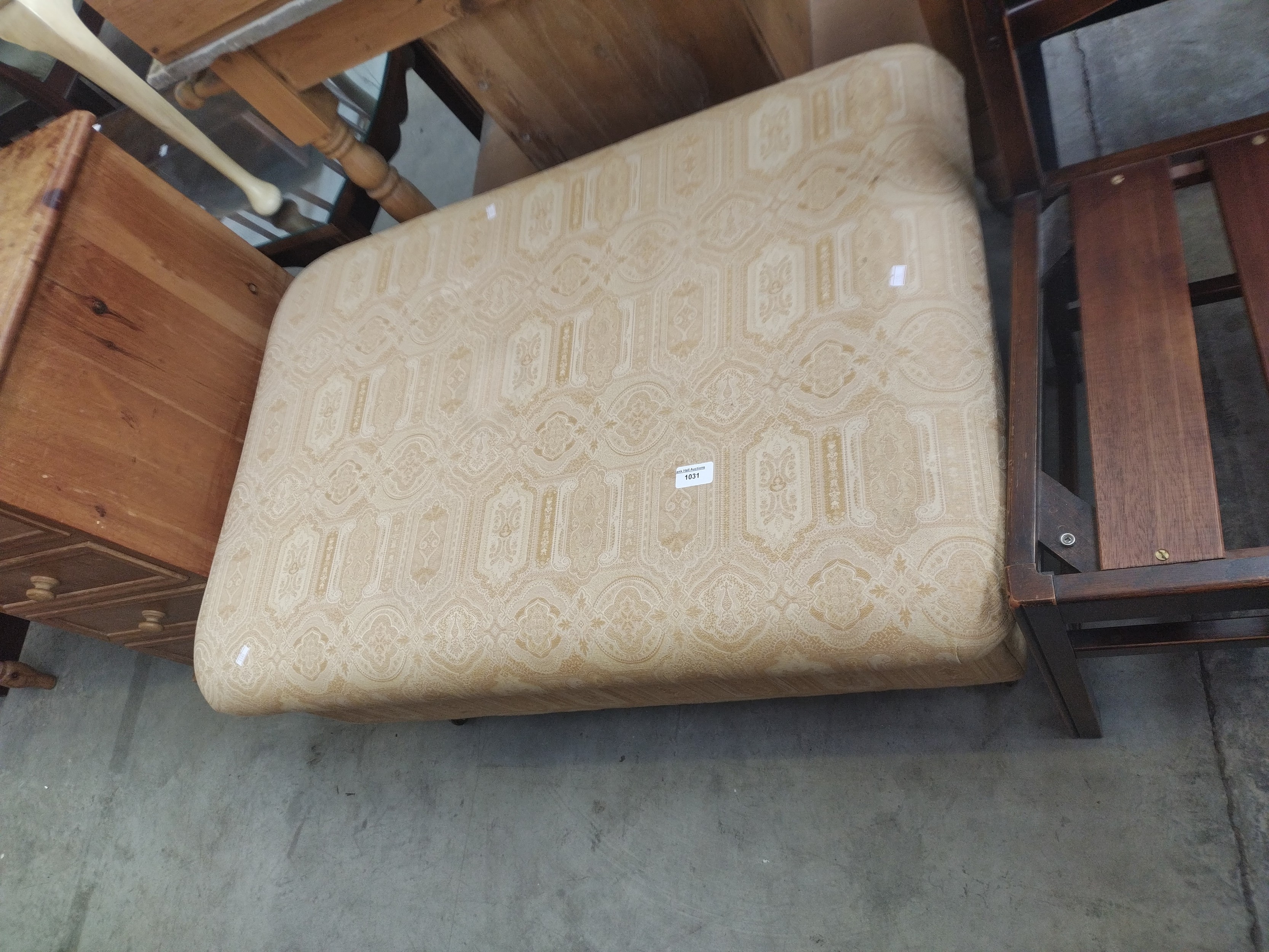A large upholstered lift top Ottoman storage pouffe