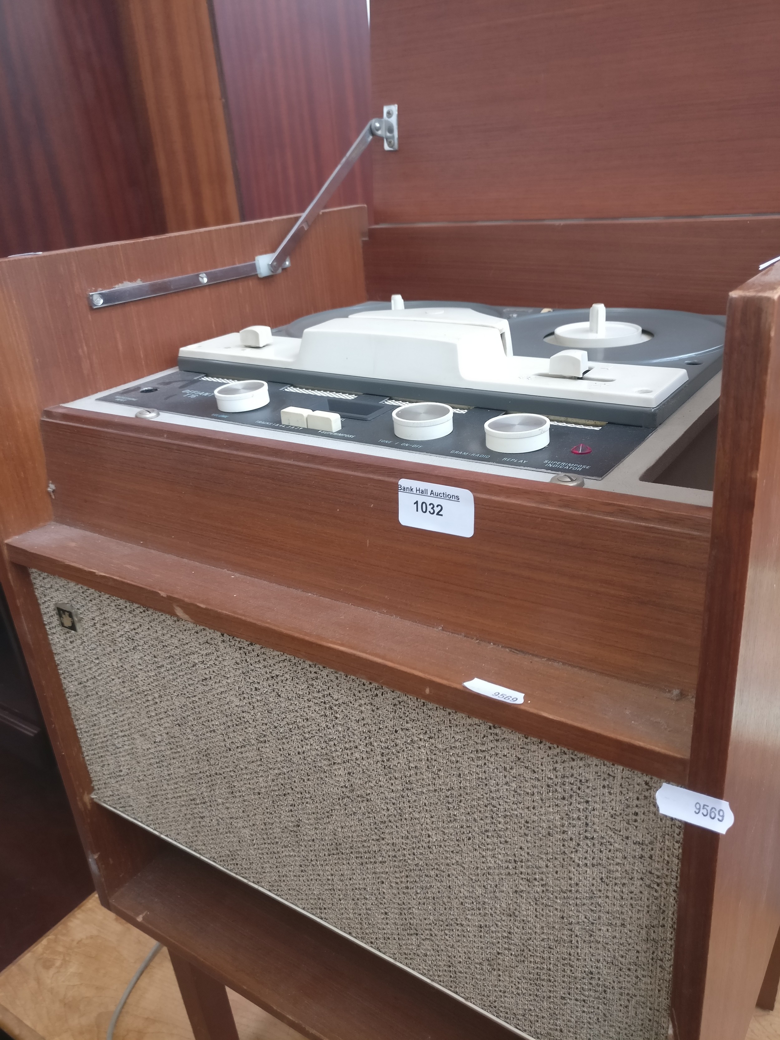 A small vintage DEFIANT T16 reel to reel tape deck in cabinet