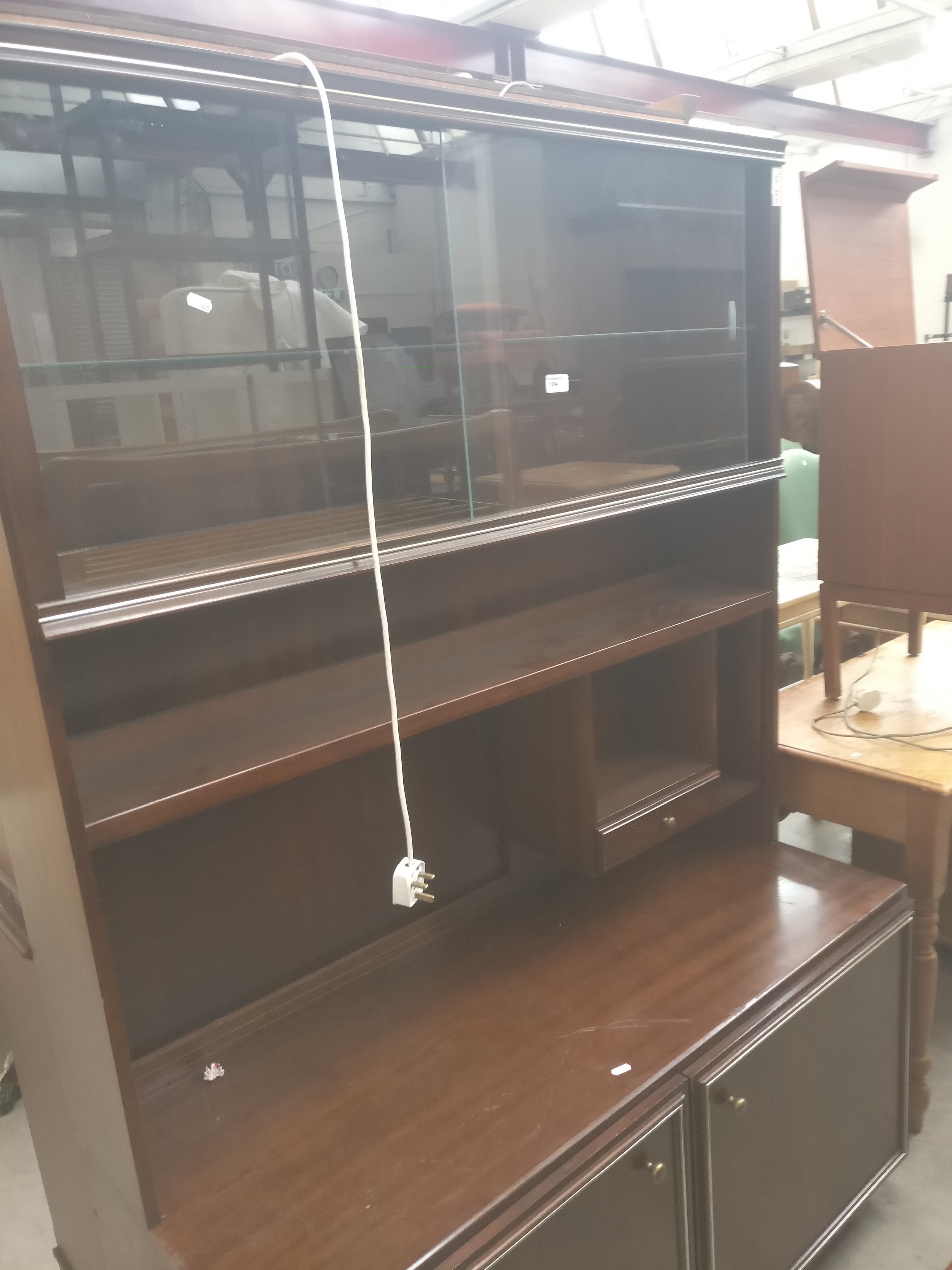 A large vintage mahogany wall unit with glazed upper cabinet and 2 door cupboard