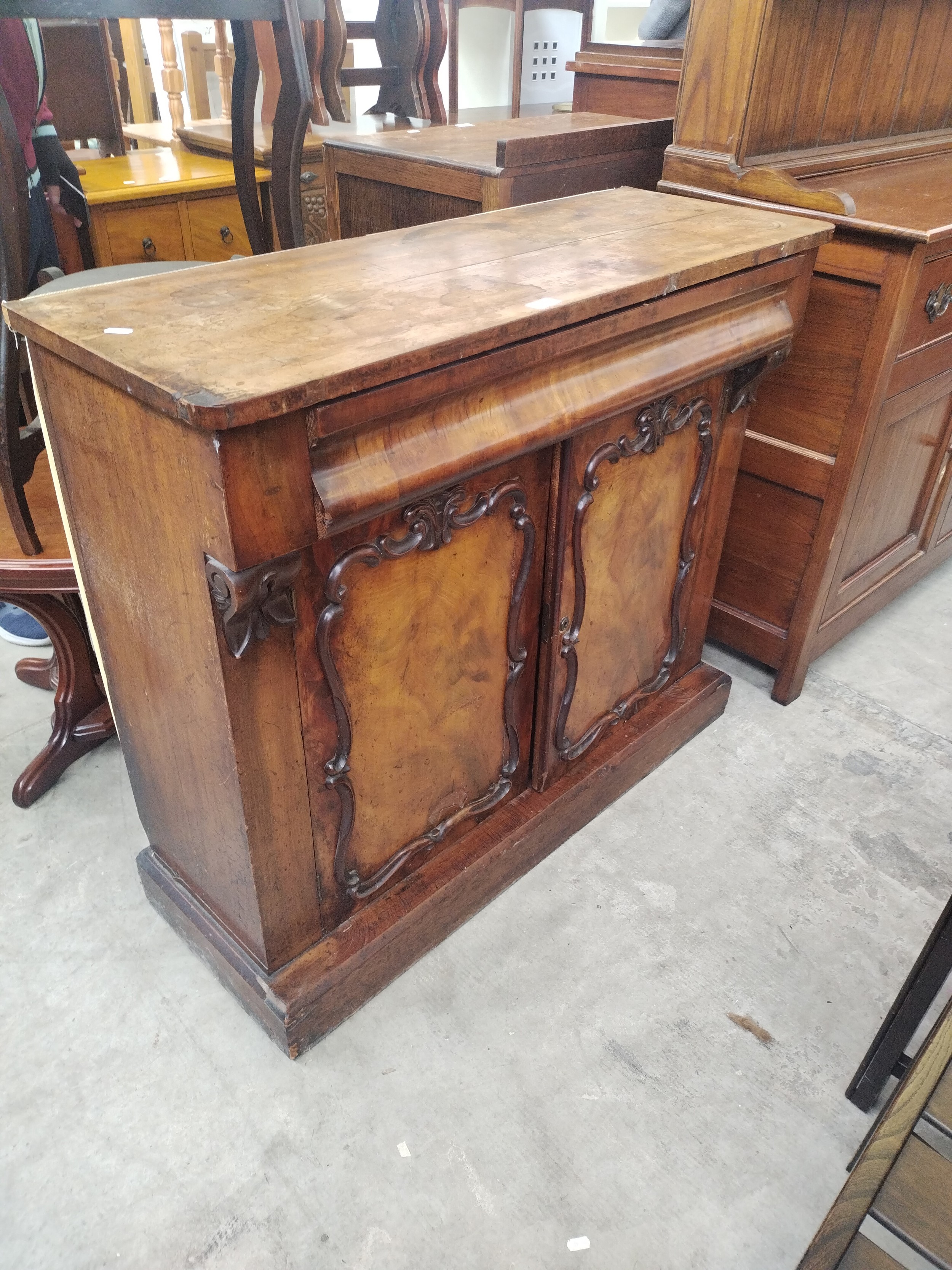A vintage Credenza base unit sideboard with single drawer and carved decorative