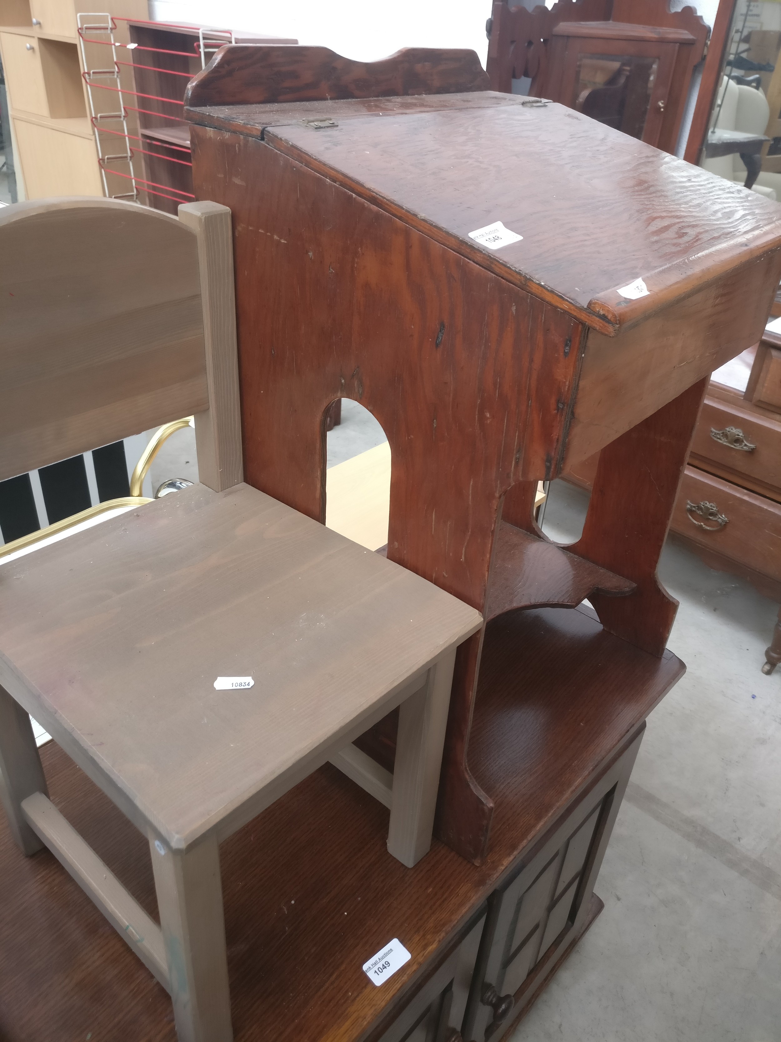 A child's small vintage lift top school desk and a small modern wooden chair