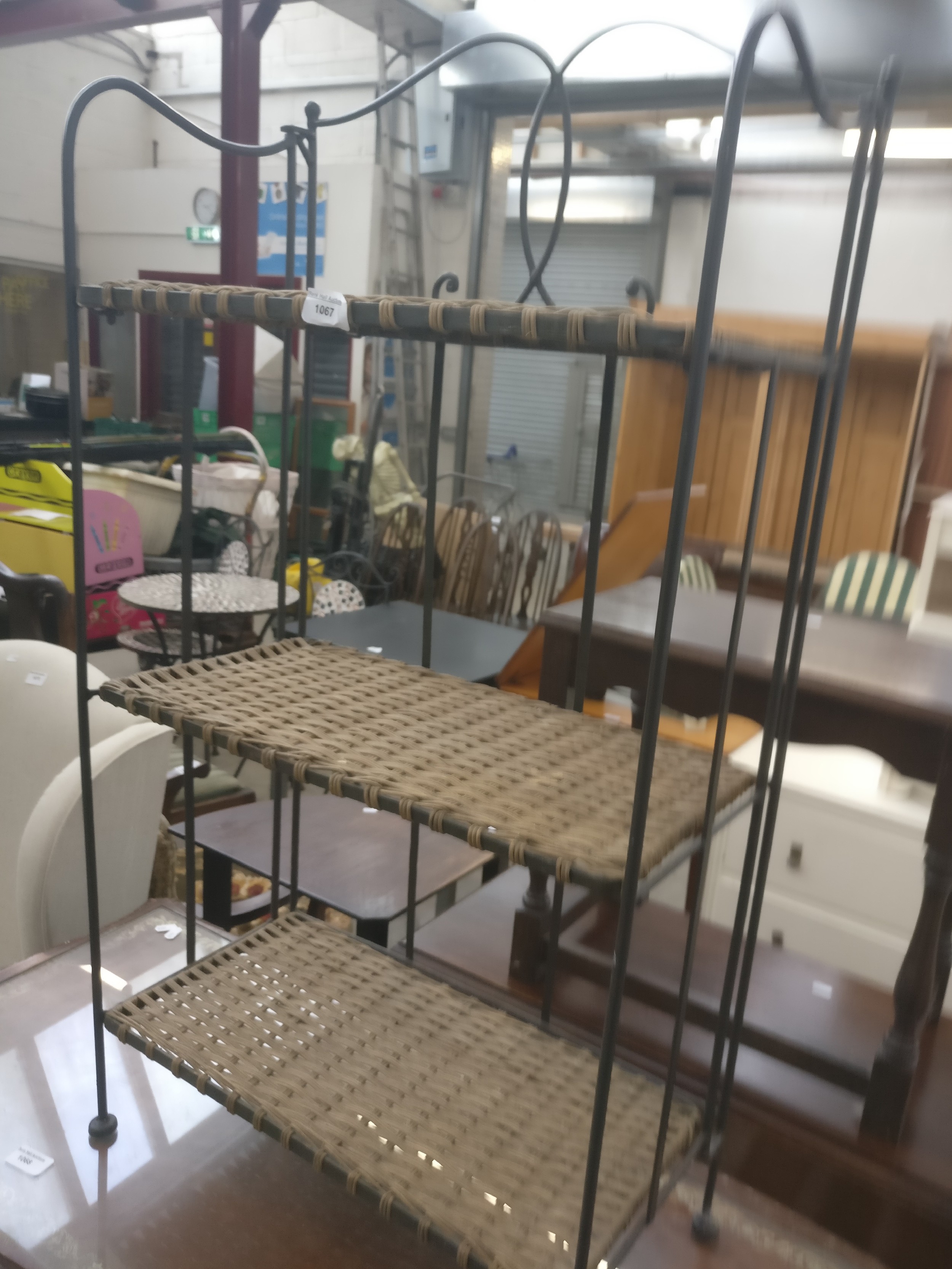 A small vintage folding metal framed 3 tier shelf stand