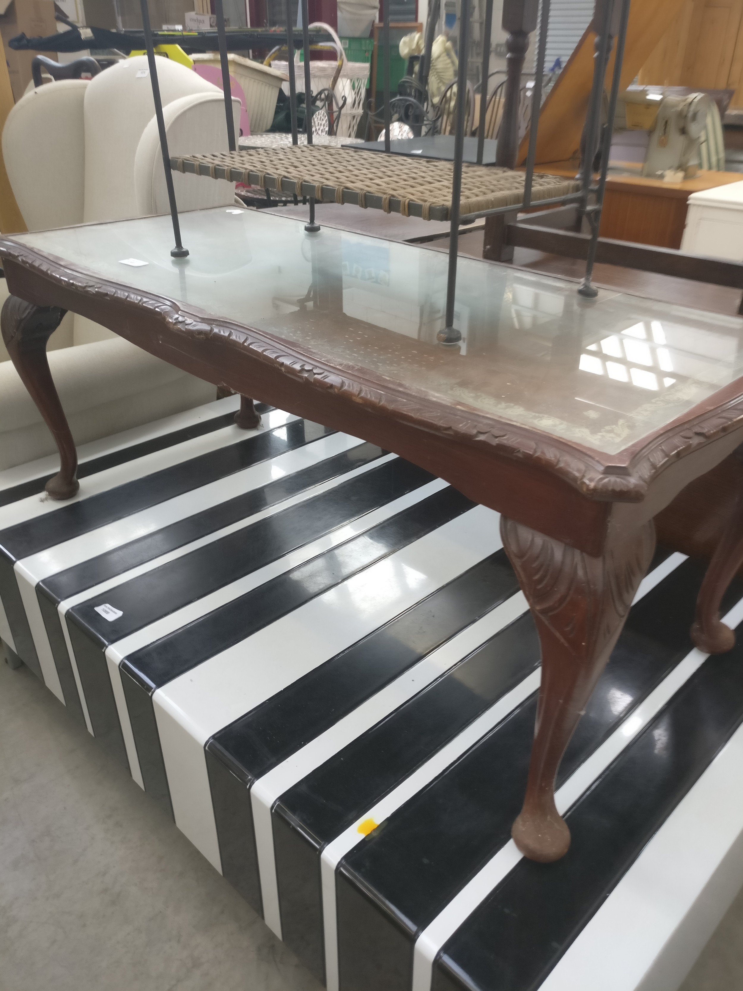 A vintage leather/glass topped coffee table
