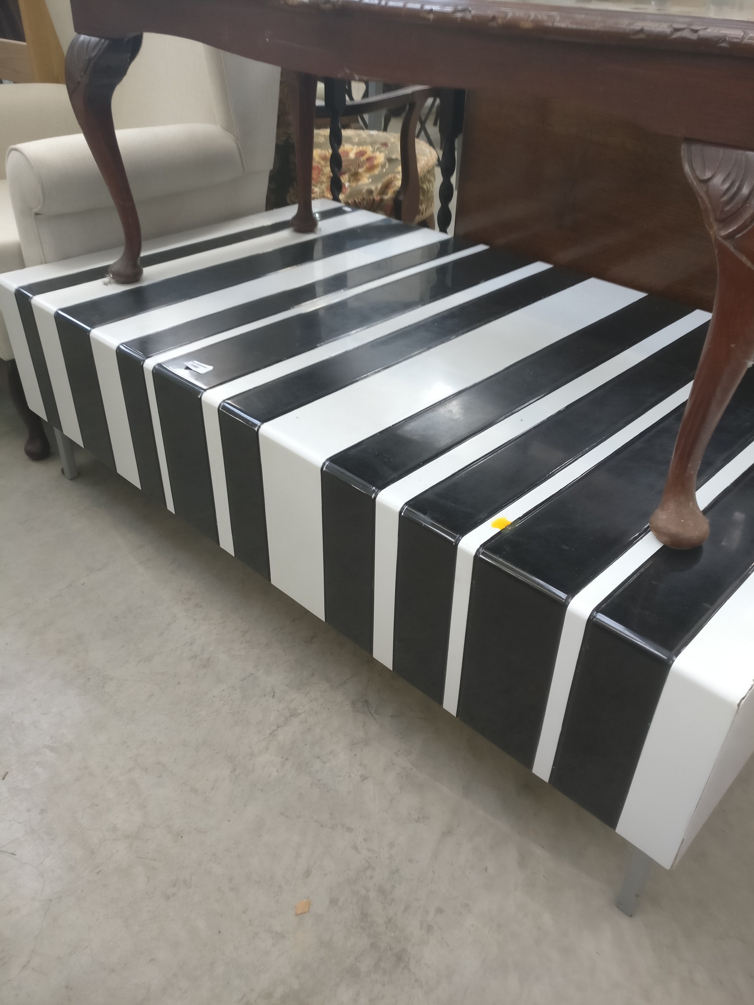A modern black and white plastic coated coffee table unit with end drawers