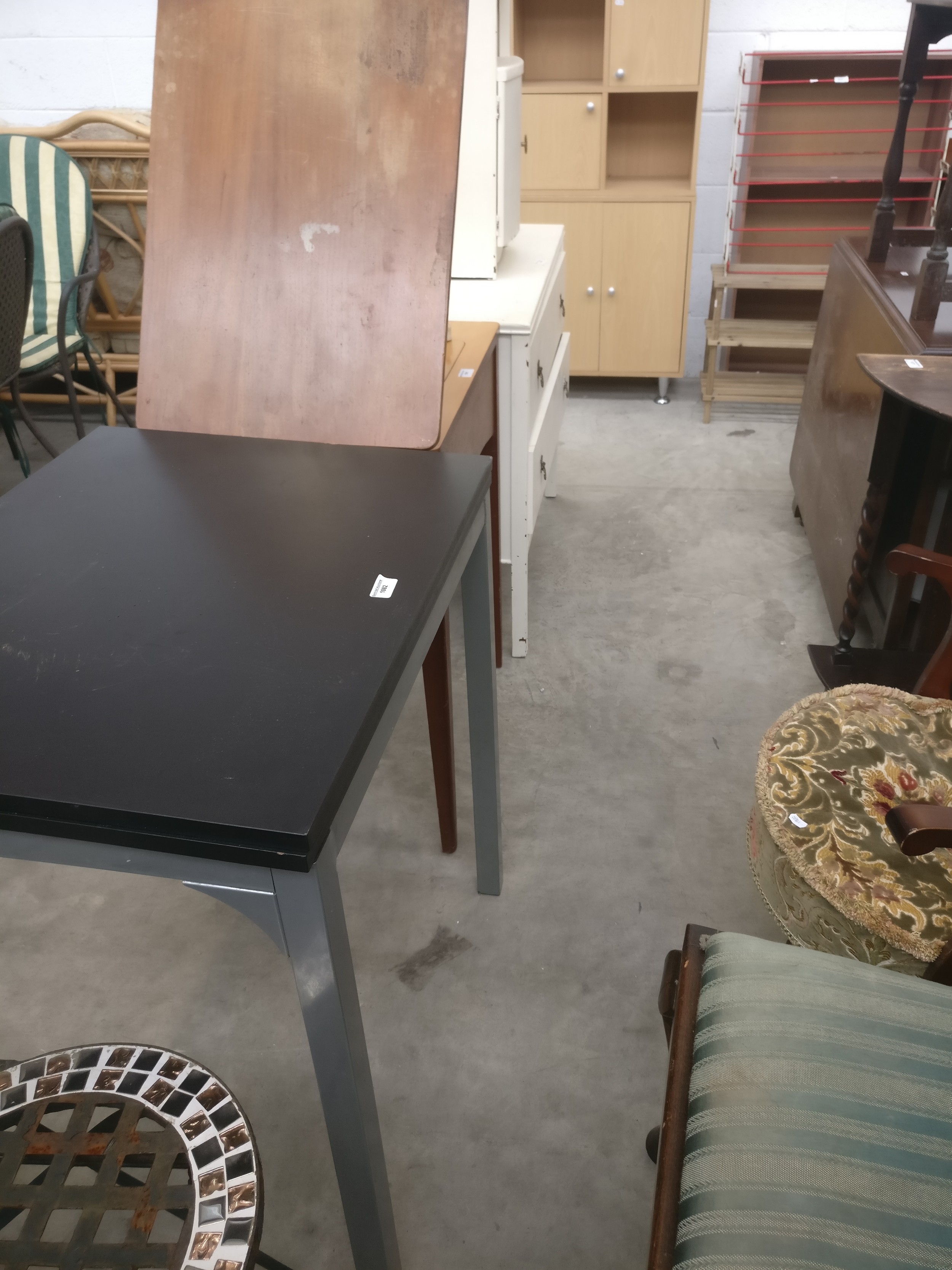 An extending fold top table on metal frame