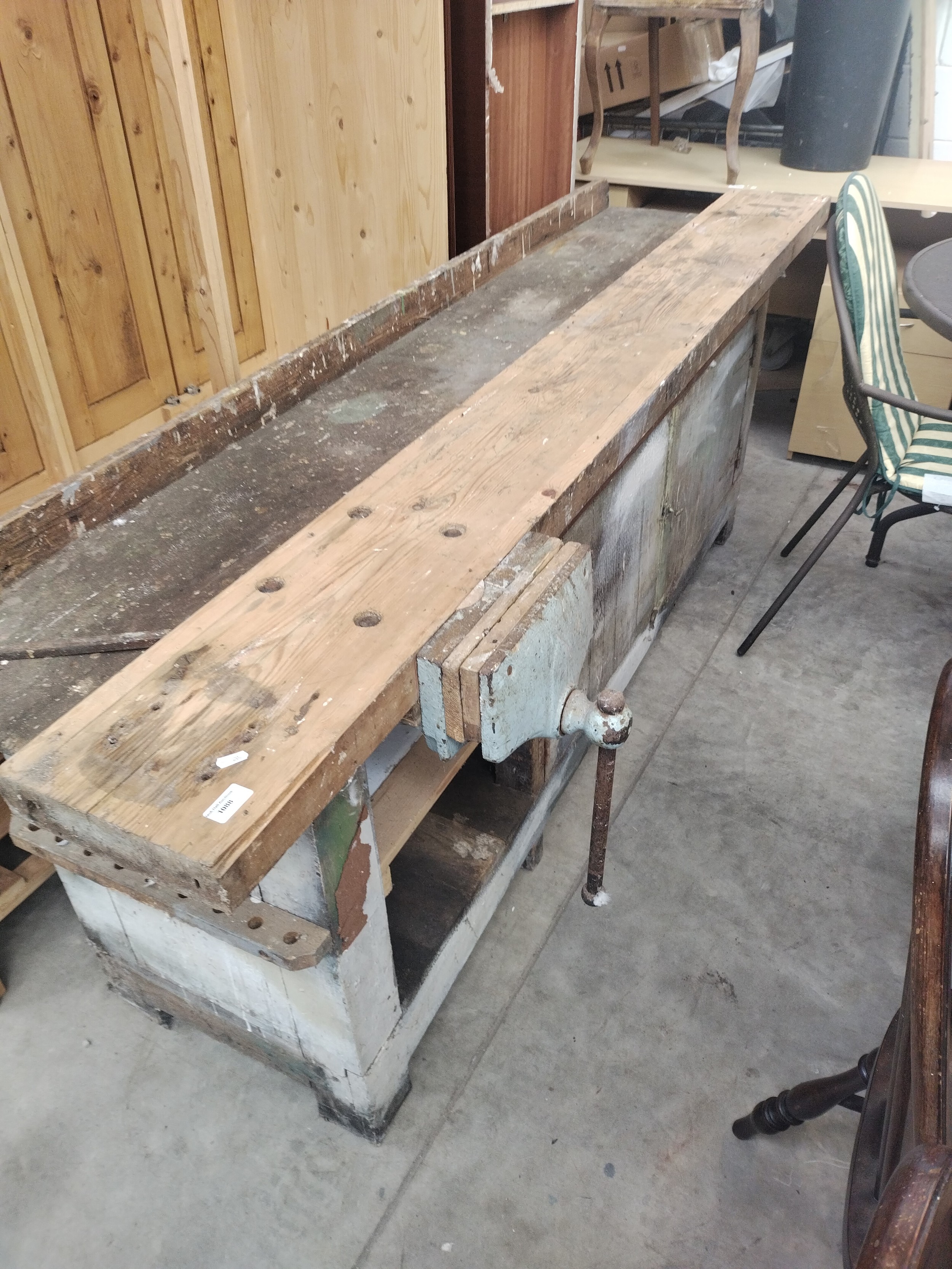 A vintage crafted 2.2 metre wide work bench with fitted vice and lower cupboards