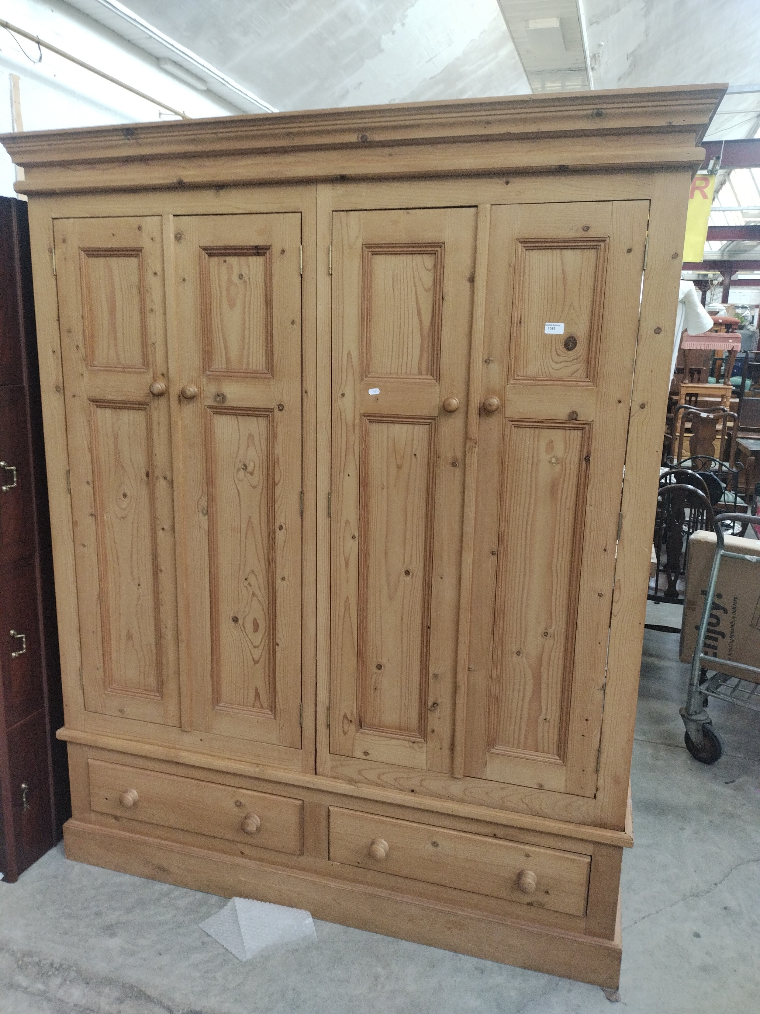 A large vintage 4 door pine wardrobe with lower drawers - no back