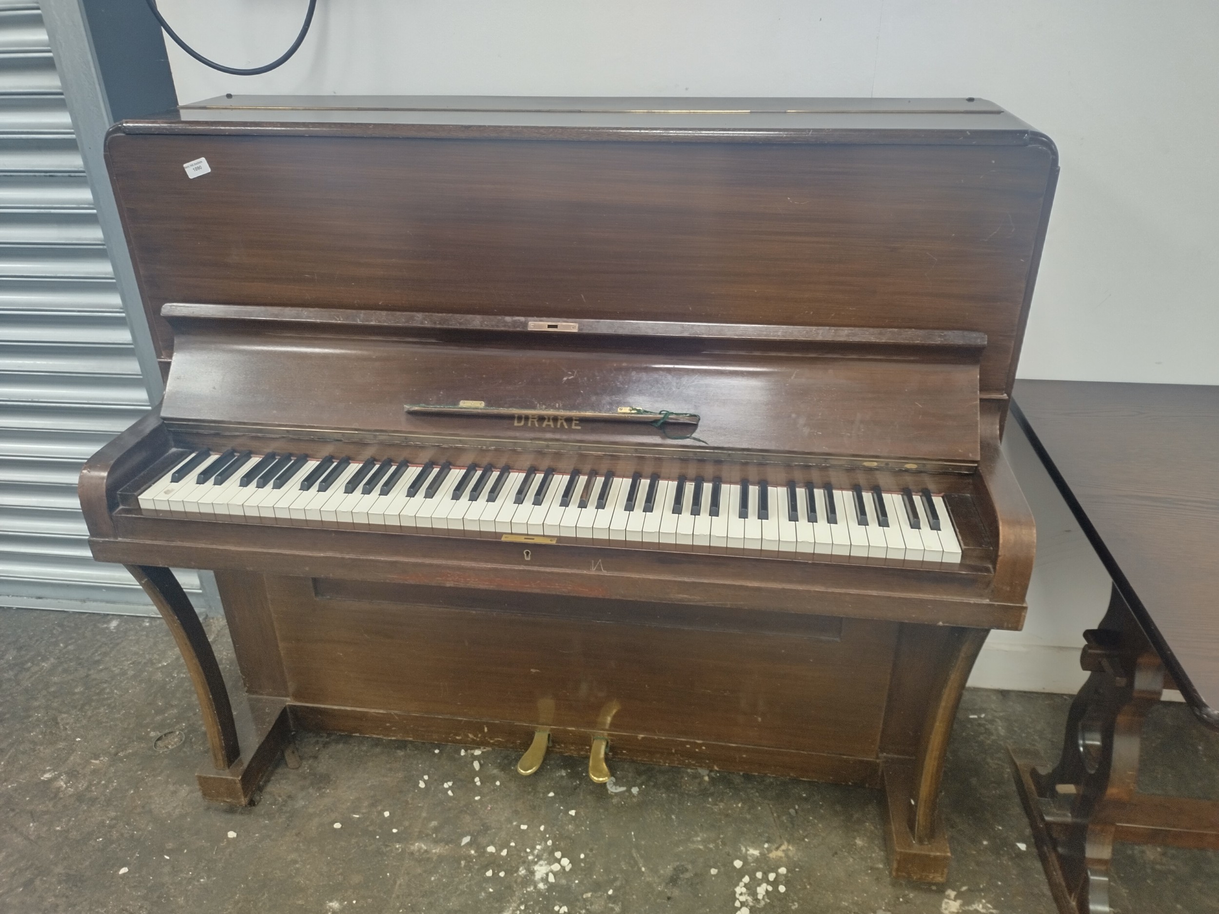 A vintage mahogany cased upright piano by DRAKE