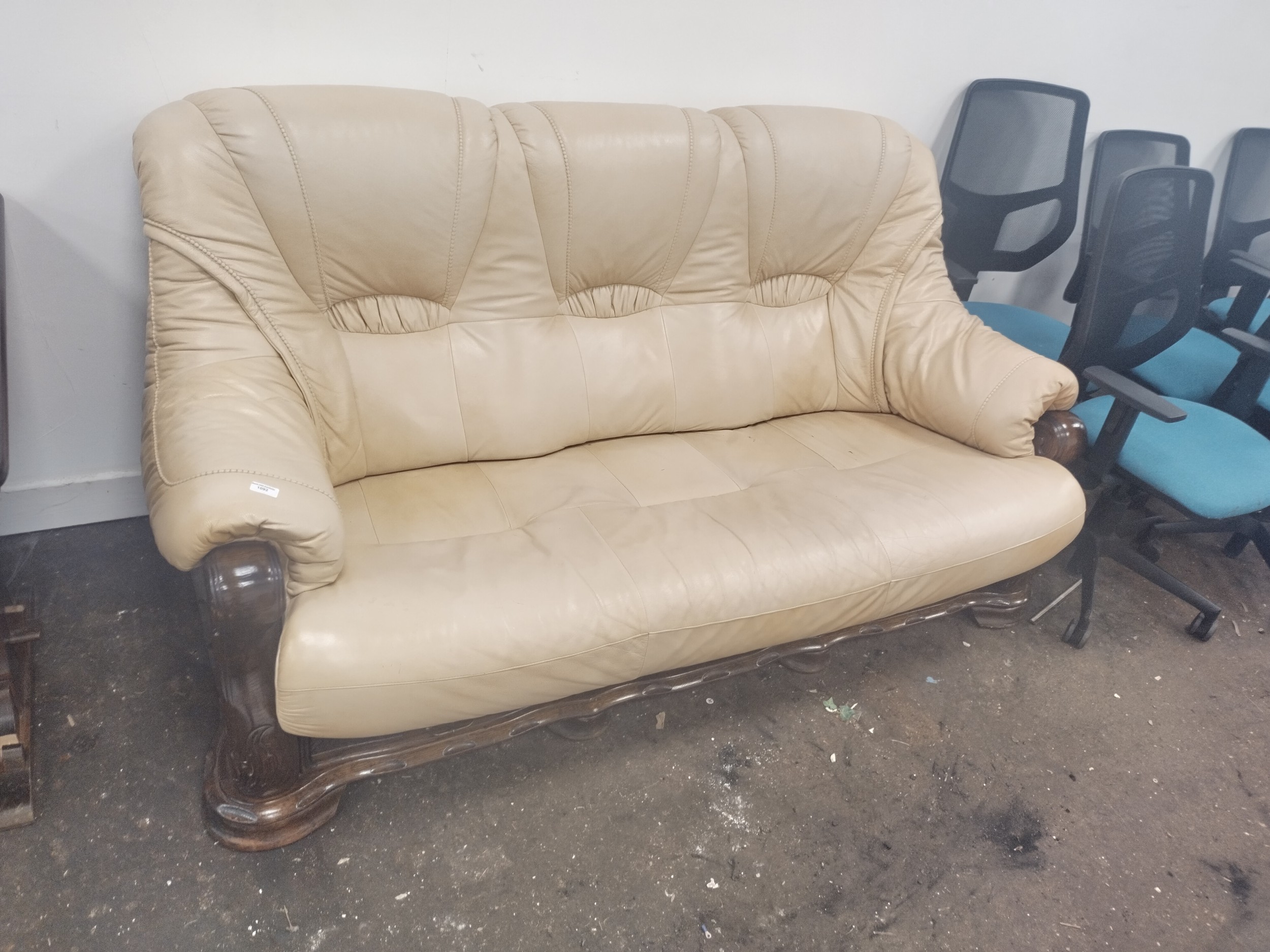 A large wood framed padded leather settee