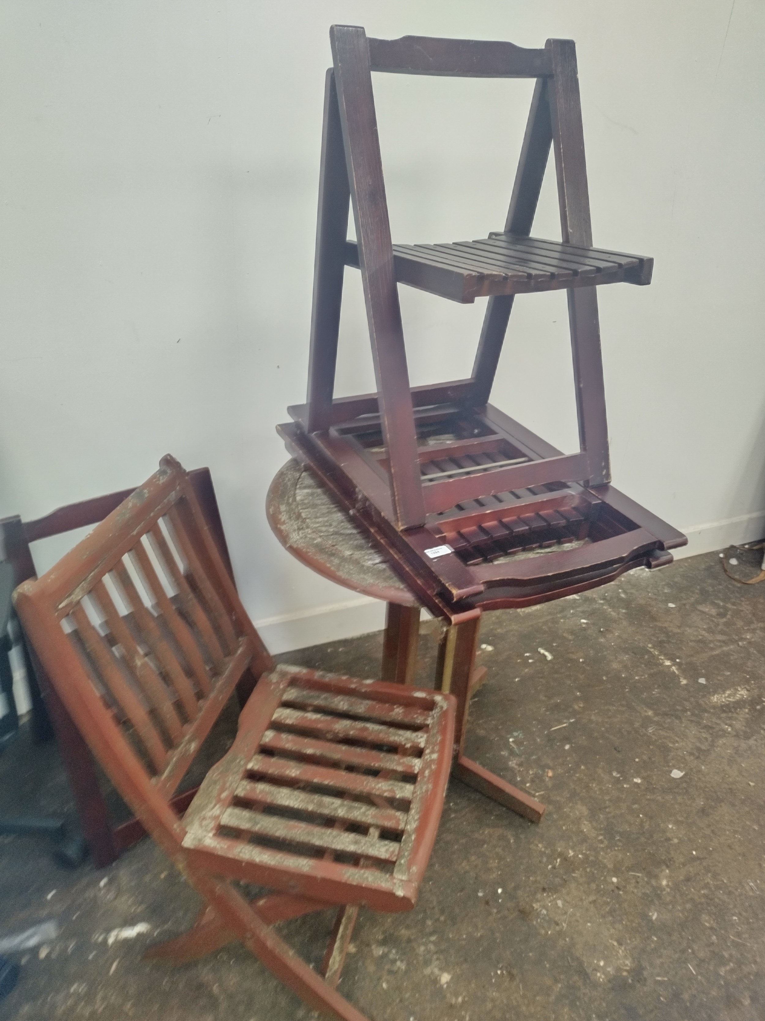 A small vintage circular wooden garden table with folding chair and a set of 4 x