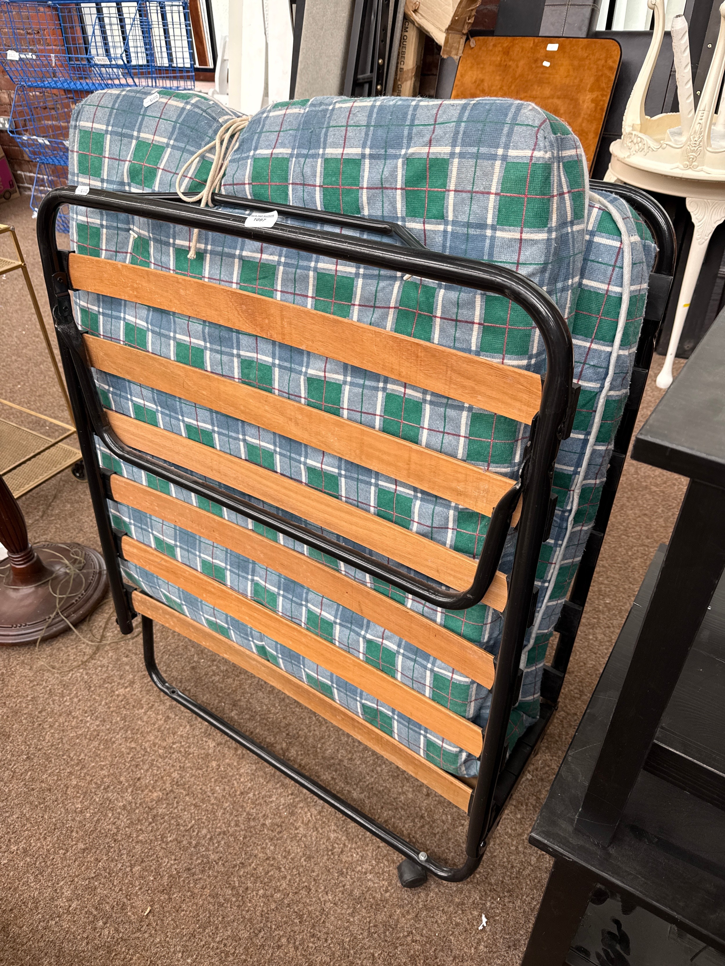 A folding guest bed with mattress