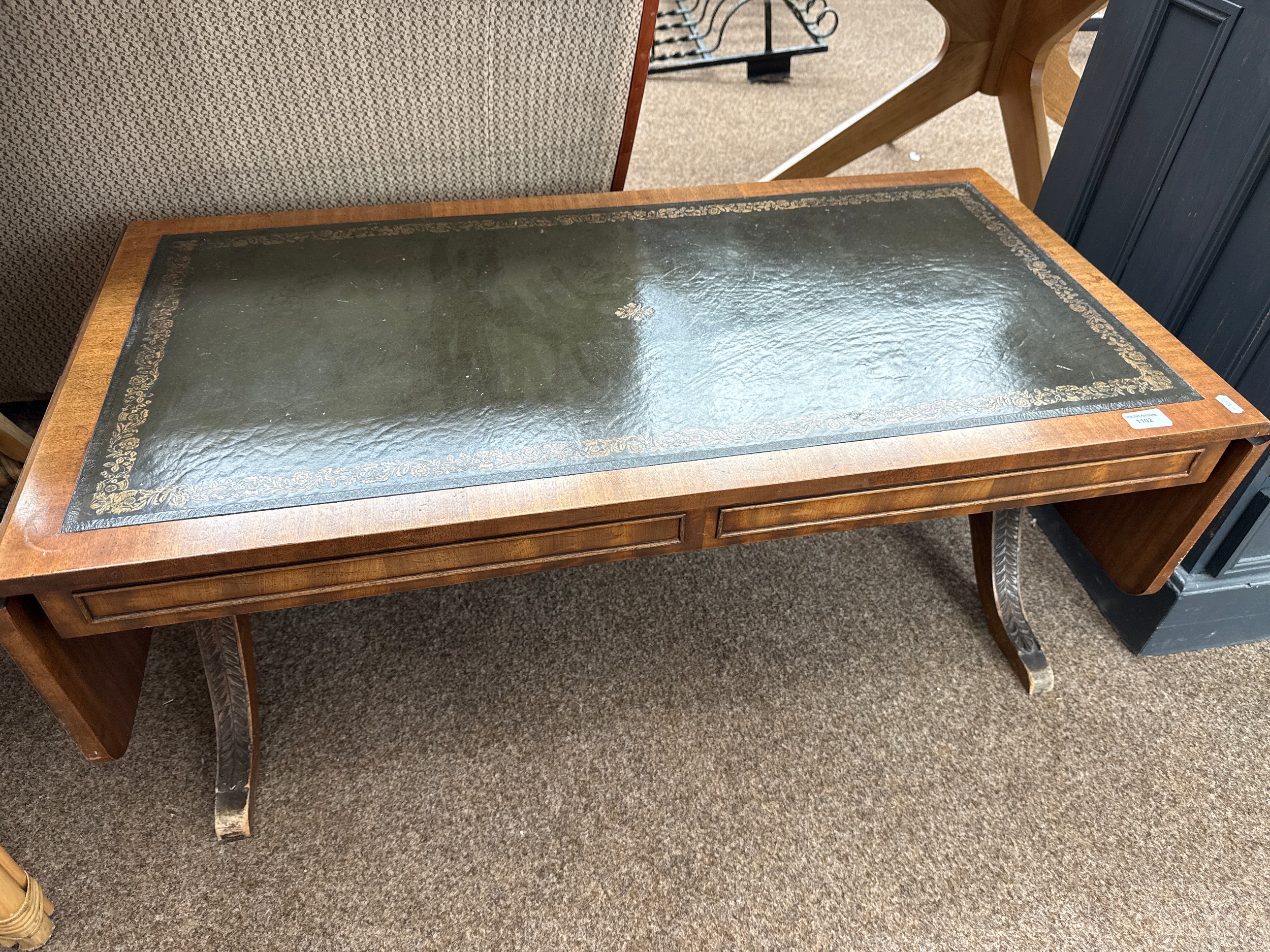 A vintage leather topped drop leaf sofa table