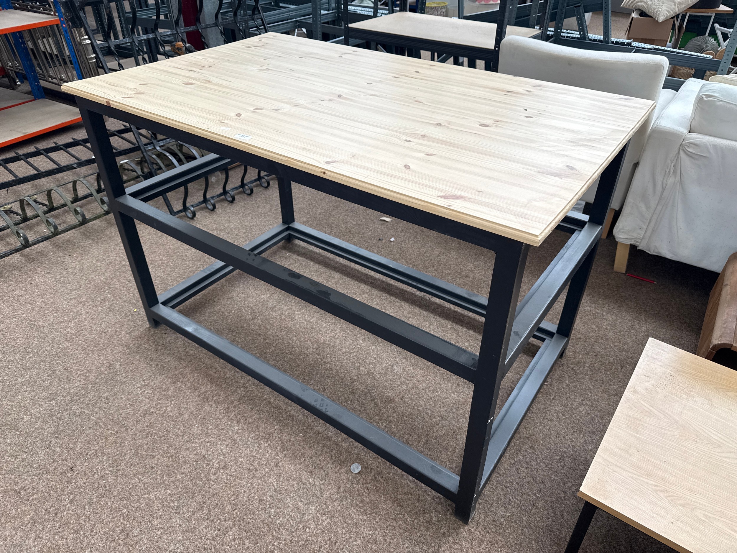A large wood framed work table unit with pine top
