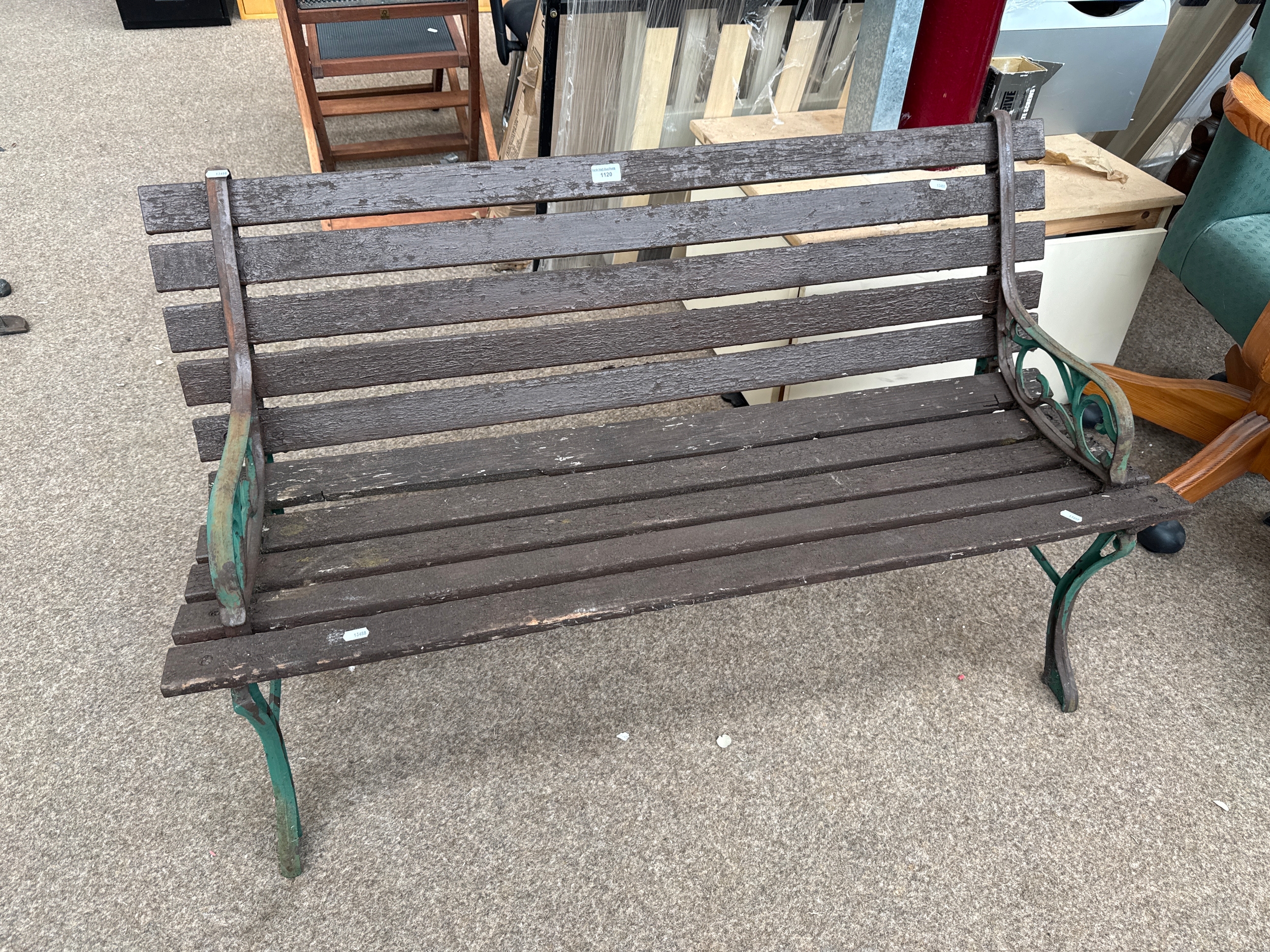 A small garden bench with cast iron frame