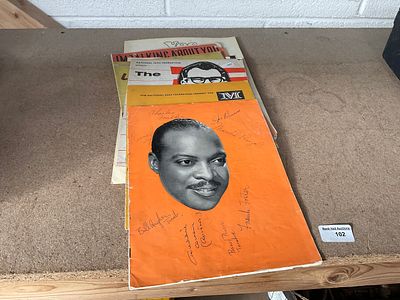 Old music magazines, one bearing signatures