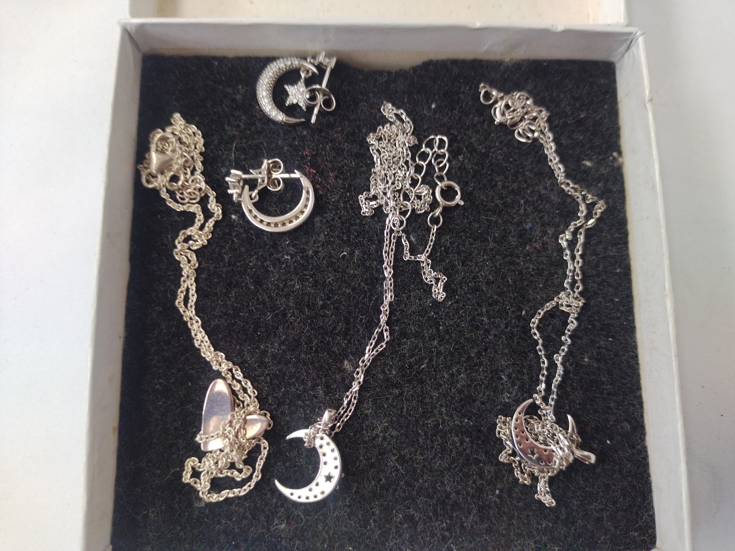 Three silver stamped necklaces with pendants and pair of earrings