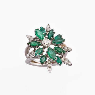 Emerald and diamond flower head ringSet with a brilliant-cut diamond, framed by marquise-shaped 