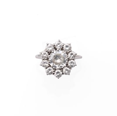 Diamond ringAn old cut diamond cluster ring. The single stone centre of approximately 1,20 