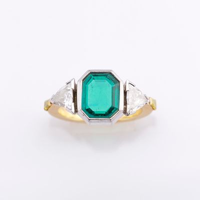 Emerald, diamond and yellow treated diamond ringFeaturing a bezel-set octagonal-shaped emerald 