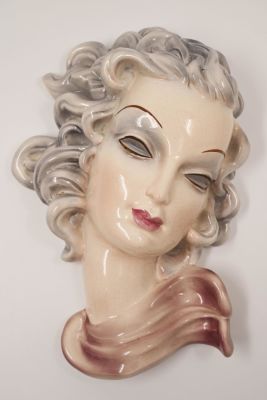 Goldscheider embossed head sculpture of a young woman, signed, size: 28 cm.