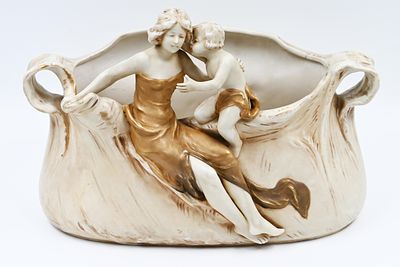 Porcelain statue - Royal Dux Bohemia. Art Nouveau from 1880. 
In the model, a mother and her 