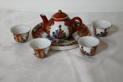 Small Chinese porcelain set, decorated with local folklore prints, including a teapot, 4 