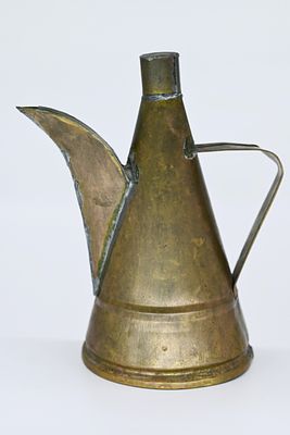 The oil can is made of copper. 
The oil can for the menorah, Netherlands, 19th century, very 