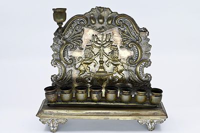 Polish silver-plated menorah, Warsaw, circa 1900, decorated with a gilded relief of lions 